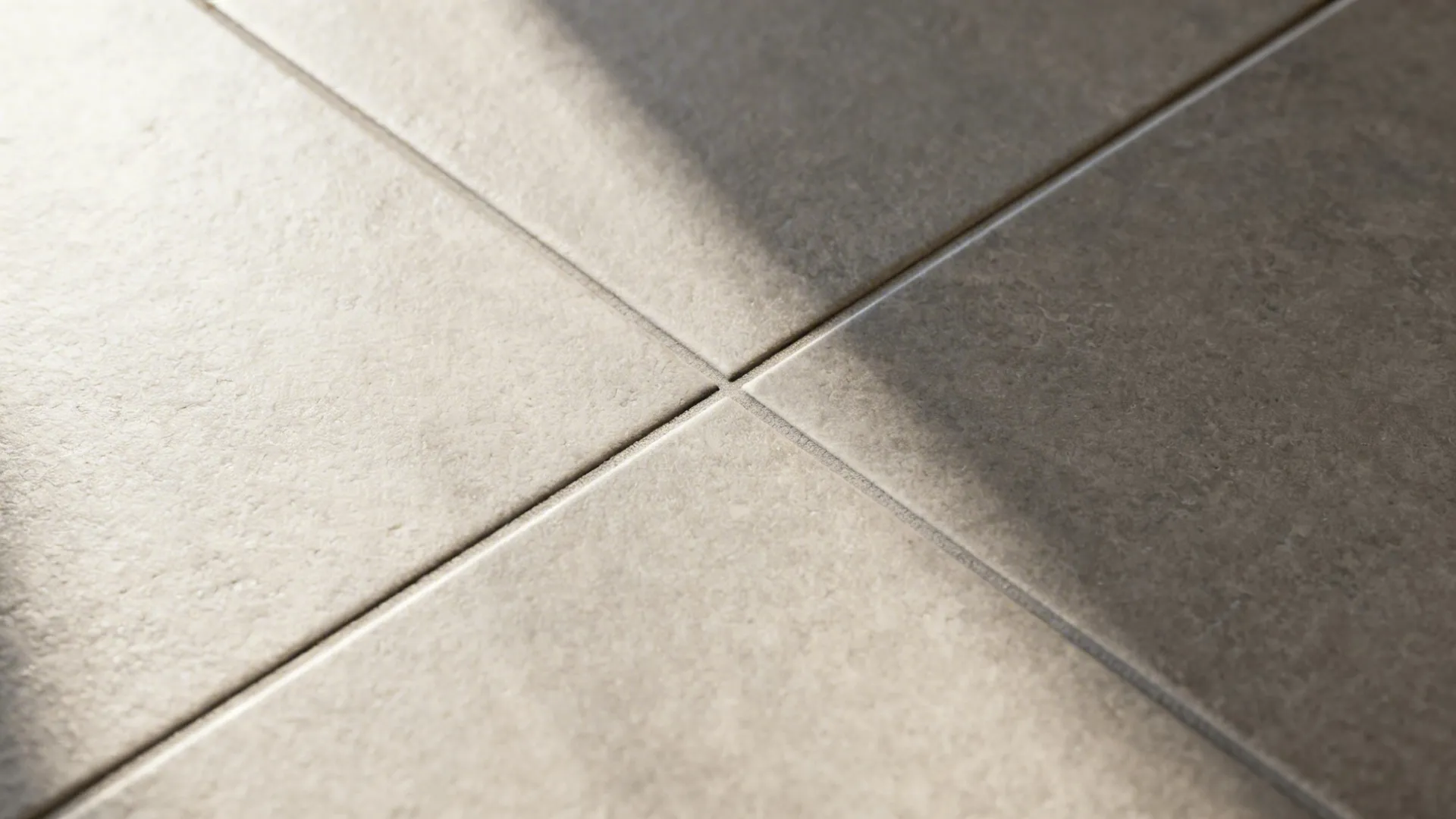 Macro detail of large-format porcelain tiles with tight, even grout joint.