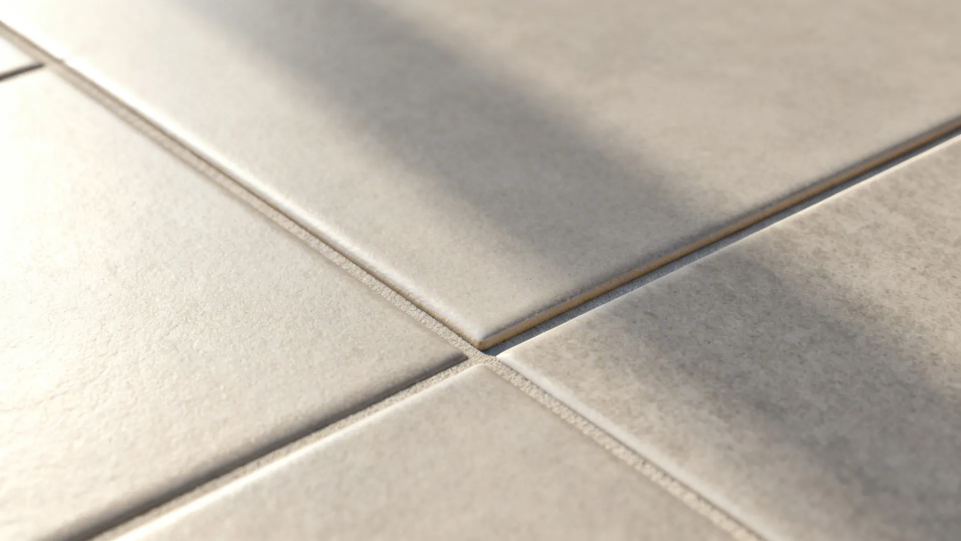 Macro of matte porcelain tile with rectified edge and tight 2 mm grout joint.