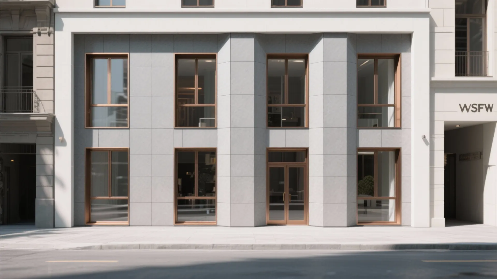 Narrow modern facade in matte mid-gray porcelain panels with tight joints and warm window frames.