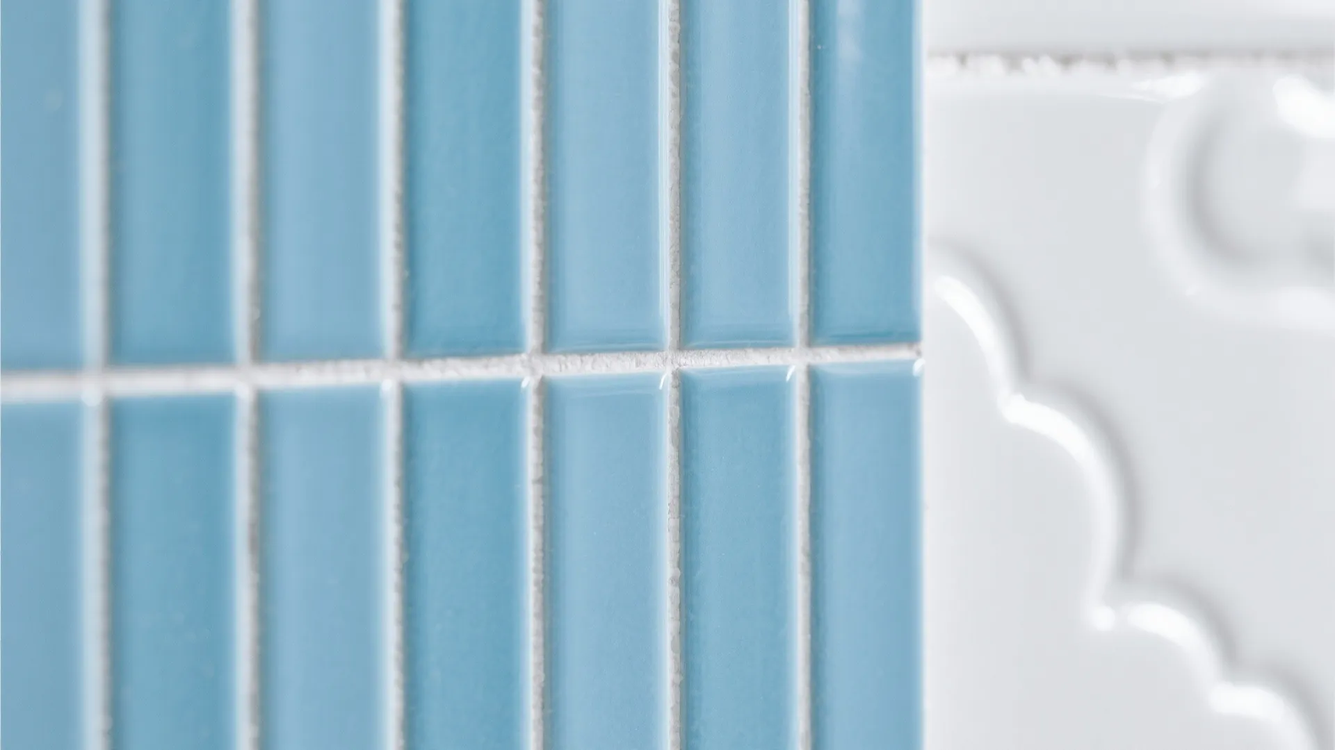 Close-up of powder blue vertical stack tiles with cloud white tile beside them.