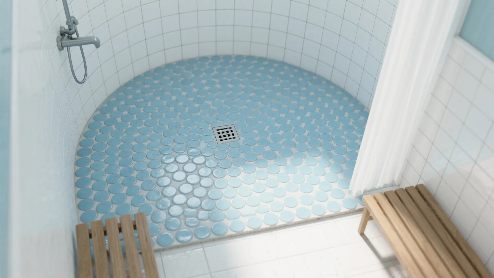 Top-down view of powder-blue penny round mosaic shower floor, curving to a drain, with white subway walls and a teak bench.