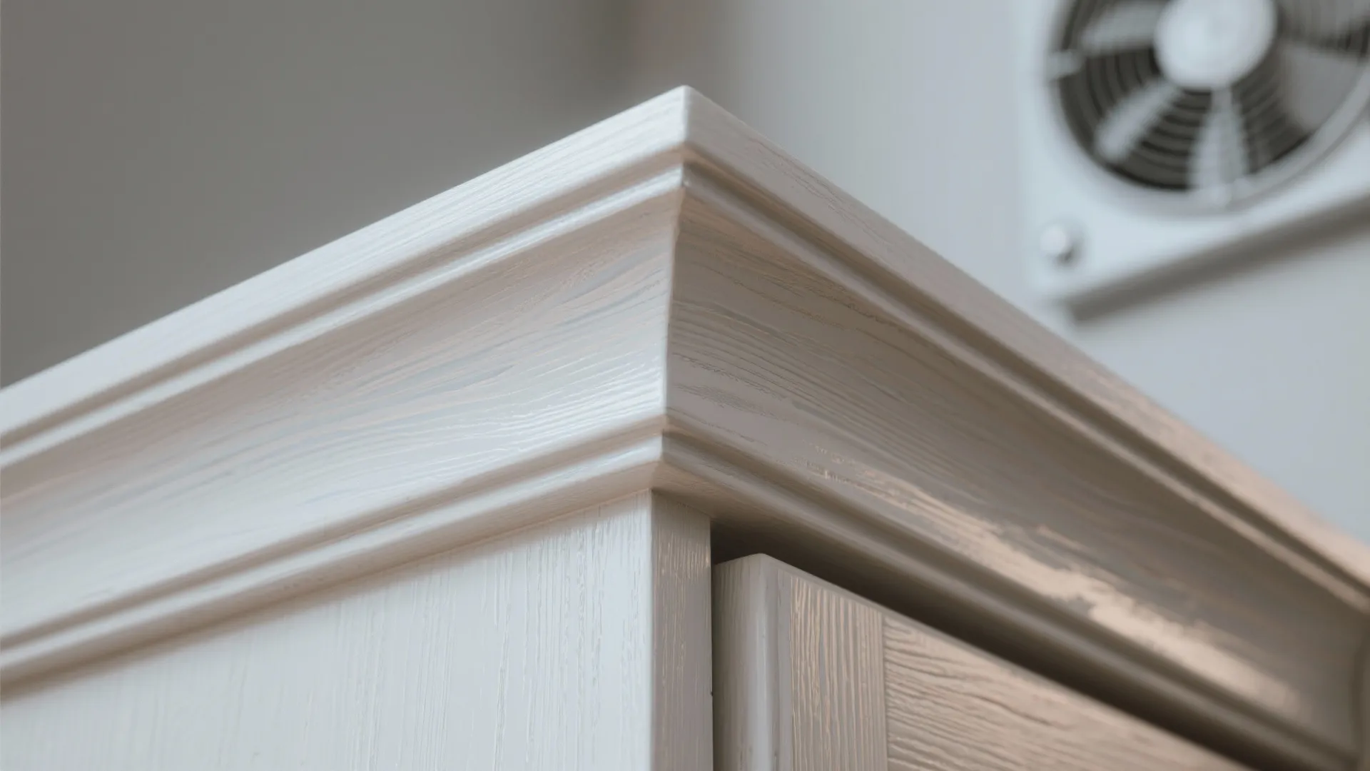 Close-up of cabinet edge showing primer and moisture-resistant topcoat detail.