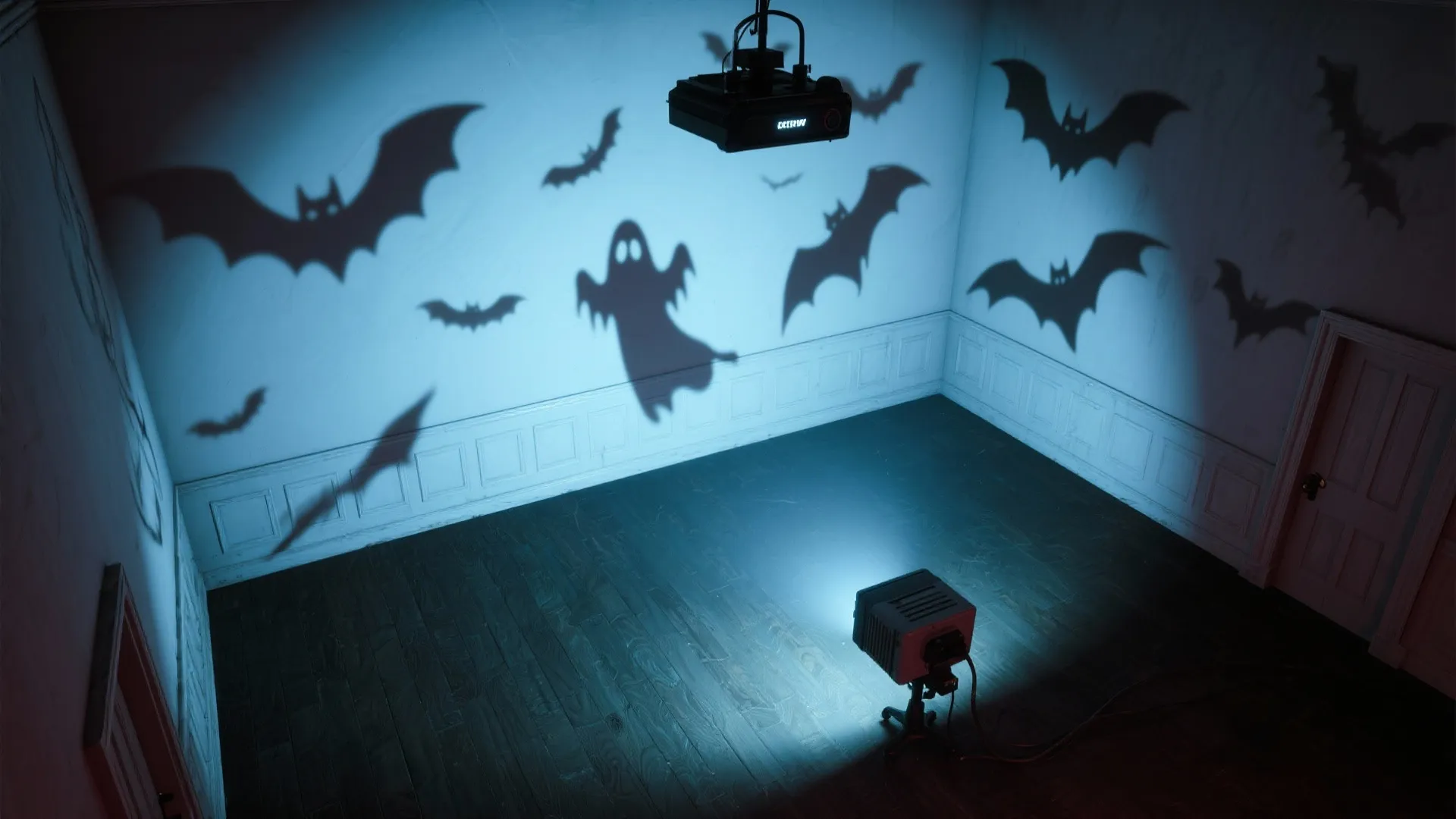 Light projector casting ghost and bat shadows onto white walls inside a dark and empty room