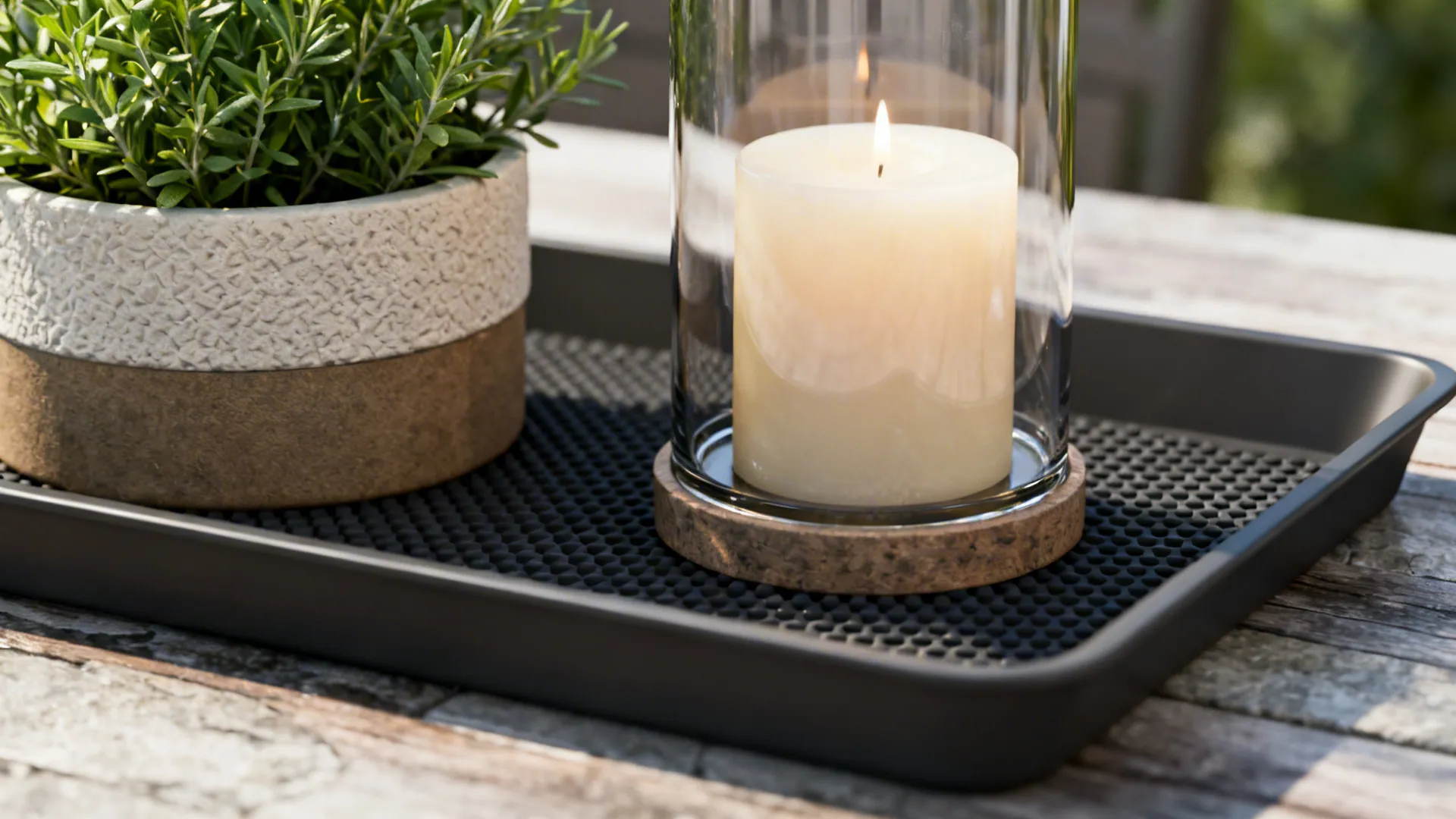 Macro detail of protective bases: waterproof liner under a potted herb and a heat-resistant tray under candles on a dining table.