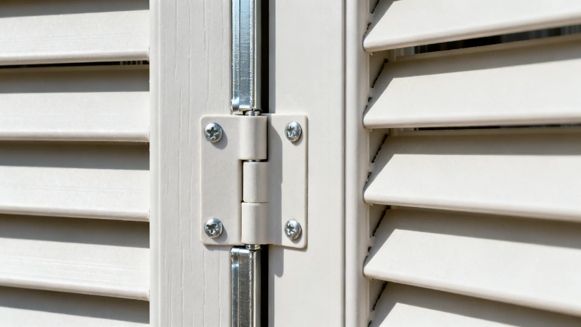 Close-up of a reinforced PVC bi-fold hinge and slotted vent detail.