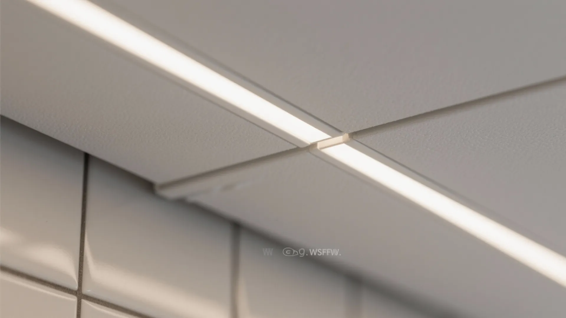 Macro detail of matte white PVC ceiling edge and recessed LED trim.