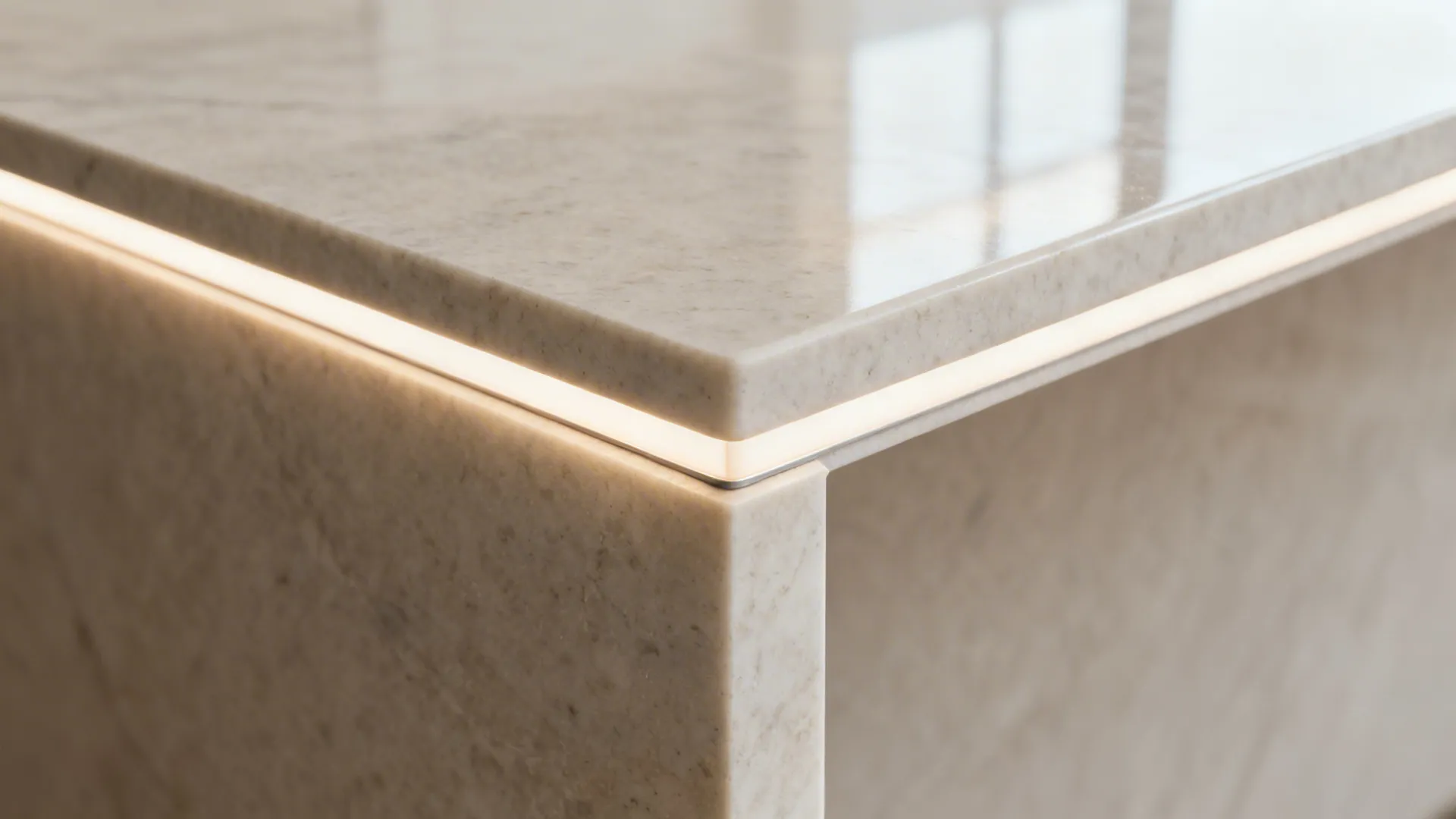 Macro of a quartz waterfall edge with eased corner and subtle LED glow.