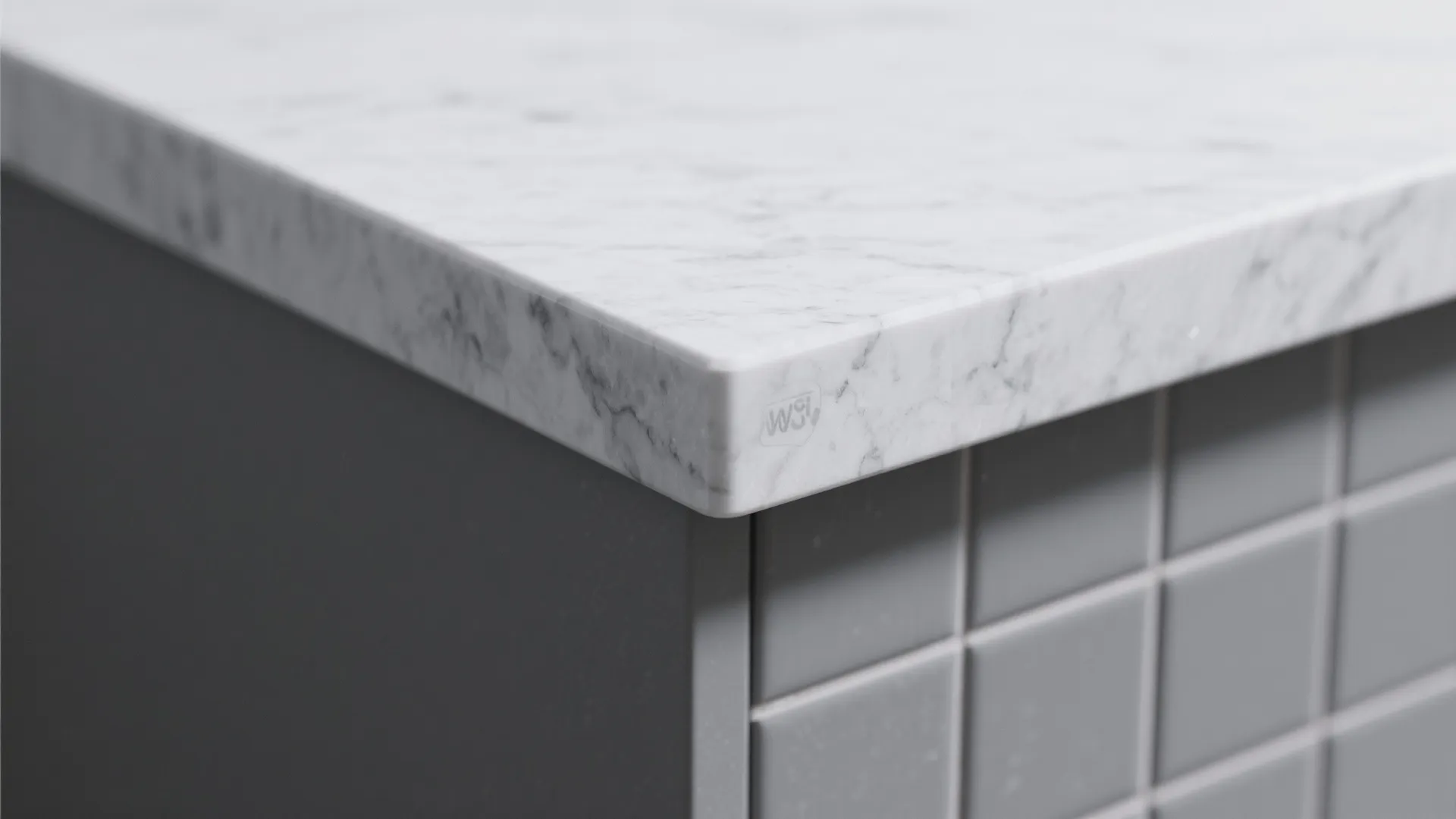 Close-up of a grey quartz countertop eased edge profile showing subtle veining and finish.