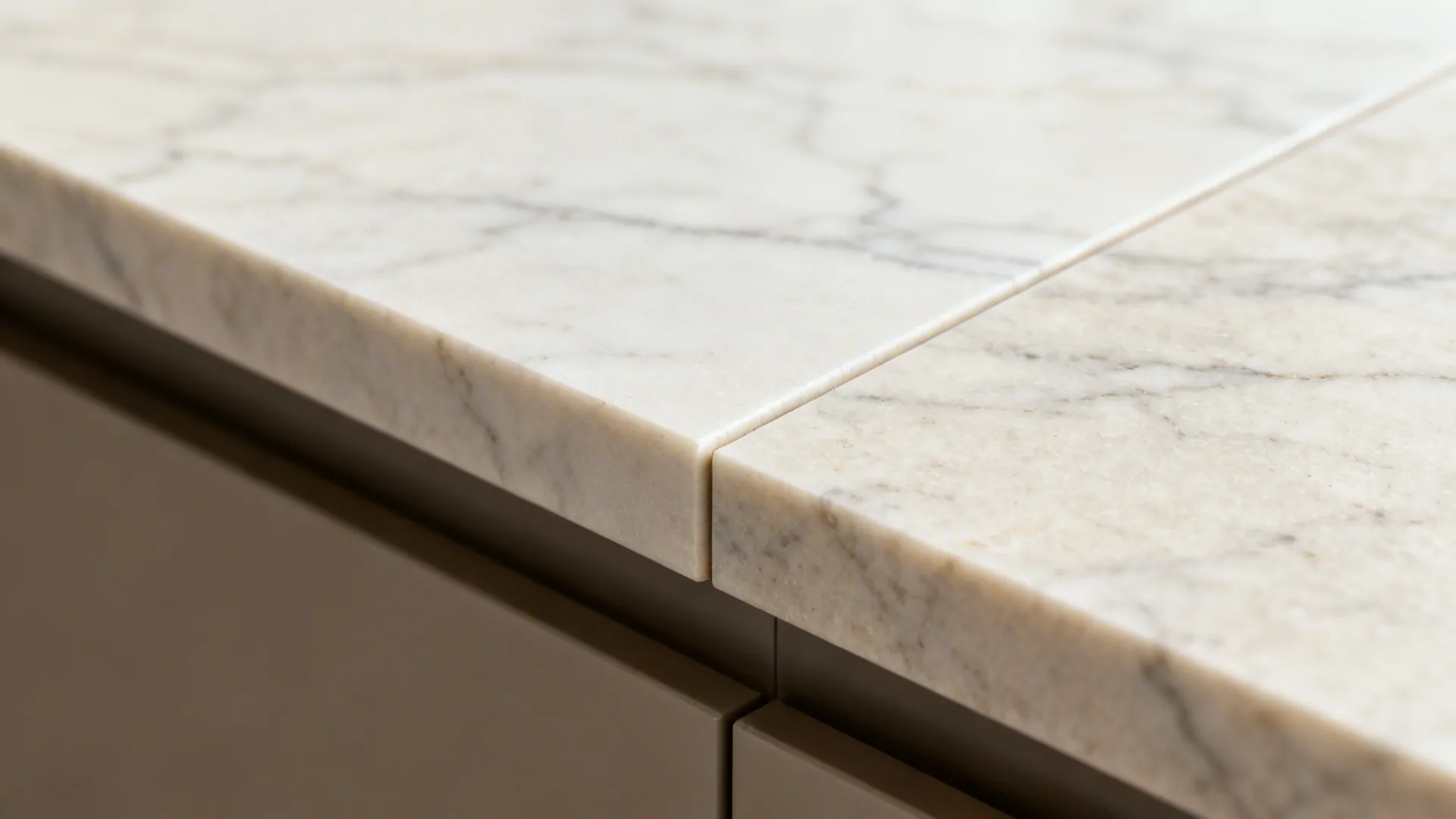 Macro view of light quartz slab with subtle veining aligning from counter to backsplash.