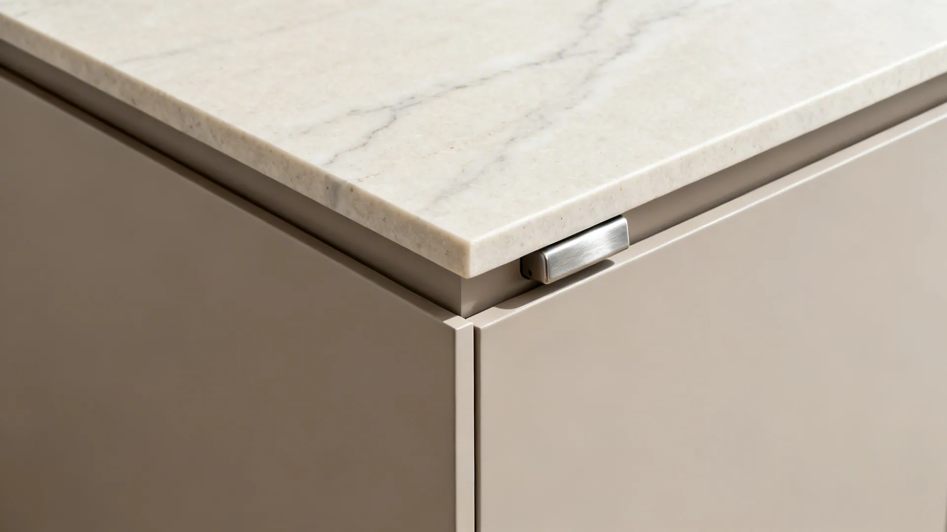 Macro of quartz waterfall miter and matte cabinet seam with refined joinery.