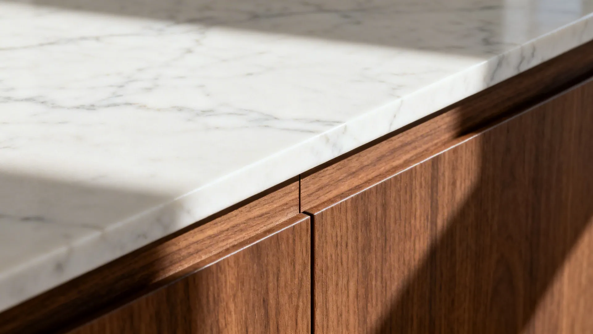 Close up of a white stone countertop surface placed on top of dark wooden kitchen cabinets