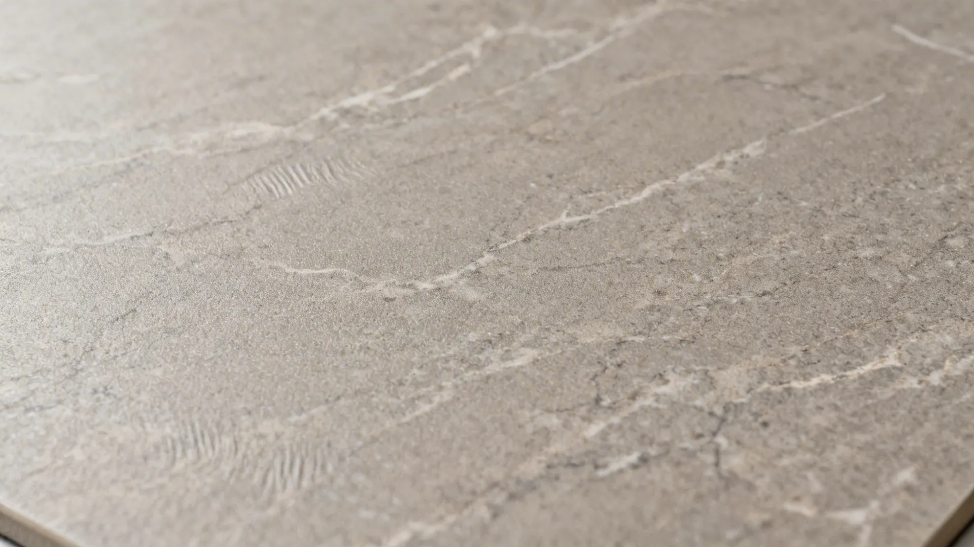 Macro of quartzite-look porcelain with subtle veining and soft lappato sheen.
