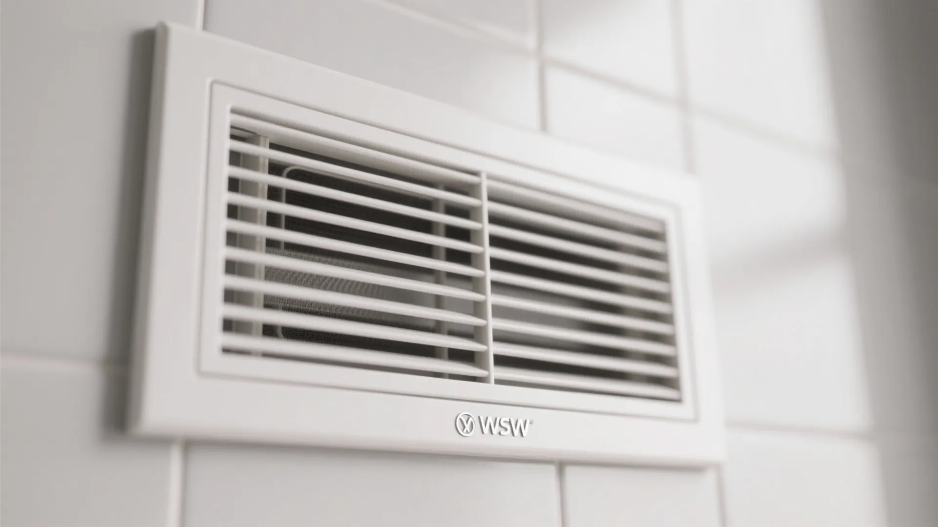White rectangular air vent cover with horizontal slats mounted on white tiled wall in a bathroom