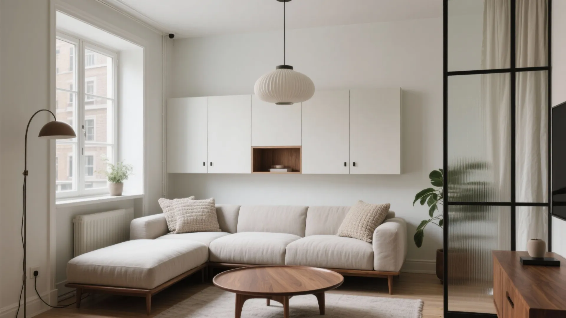 Modern living room with beige sofa white wall cabinet round wooden coffee table and ceiling light
