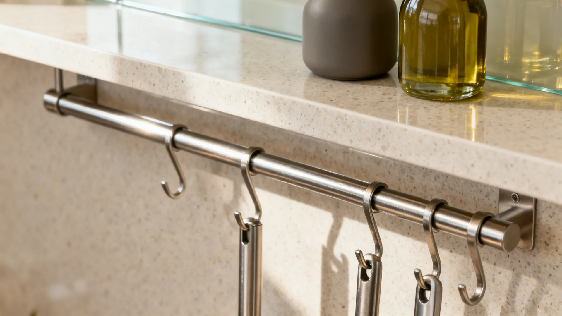 Close-up of stainless rail with hooks and a narrow shelf keeping daily tools within reach.