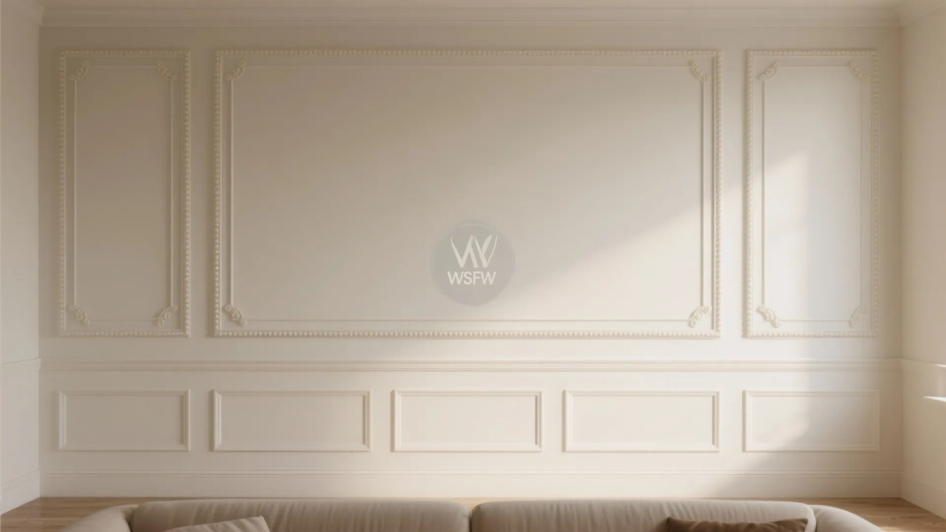 Classic interior wall with white wall panel design, decorative molding, and sofa in neutral colors