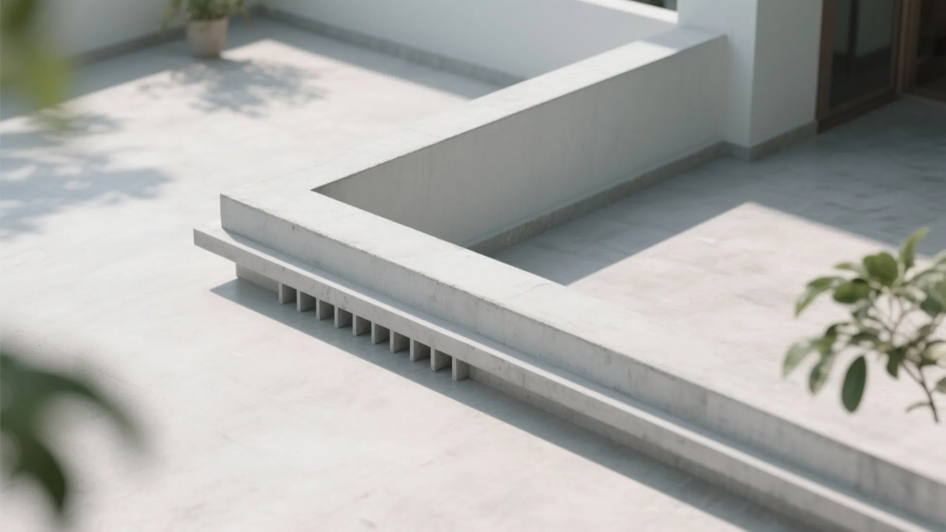 Minimalist white concrete roof balcony wall with horizontal lines and small square holes for water drainage