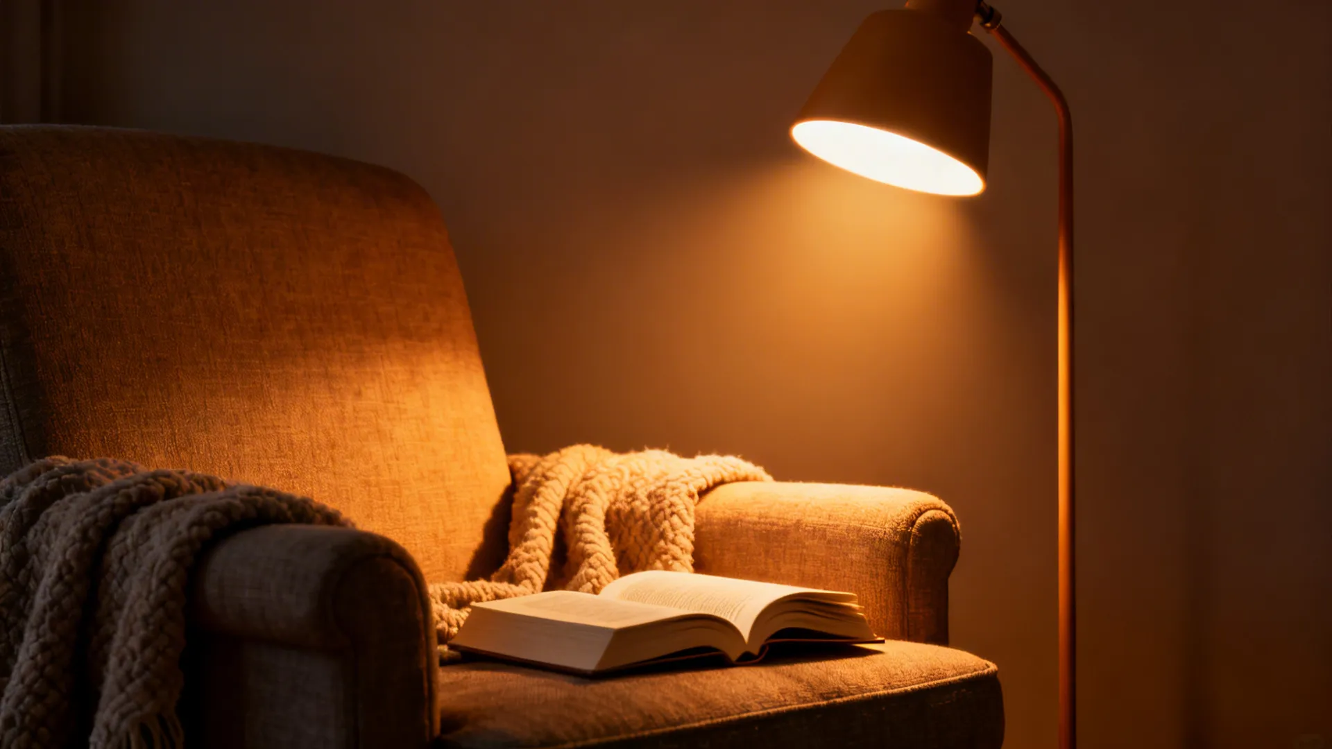 Reading nook with a warm task floor lamp casting a focused pool of light on an armchair.