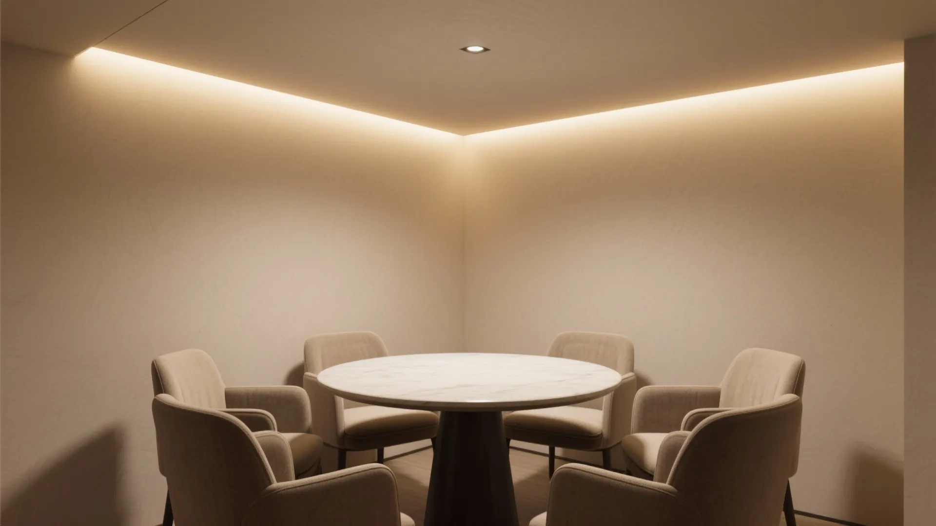 Modern dining area featuring a round marble table and beige chairs with warm hidden lighting