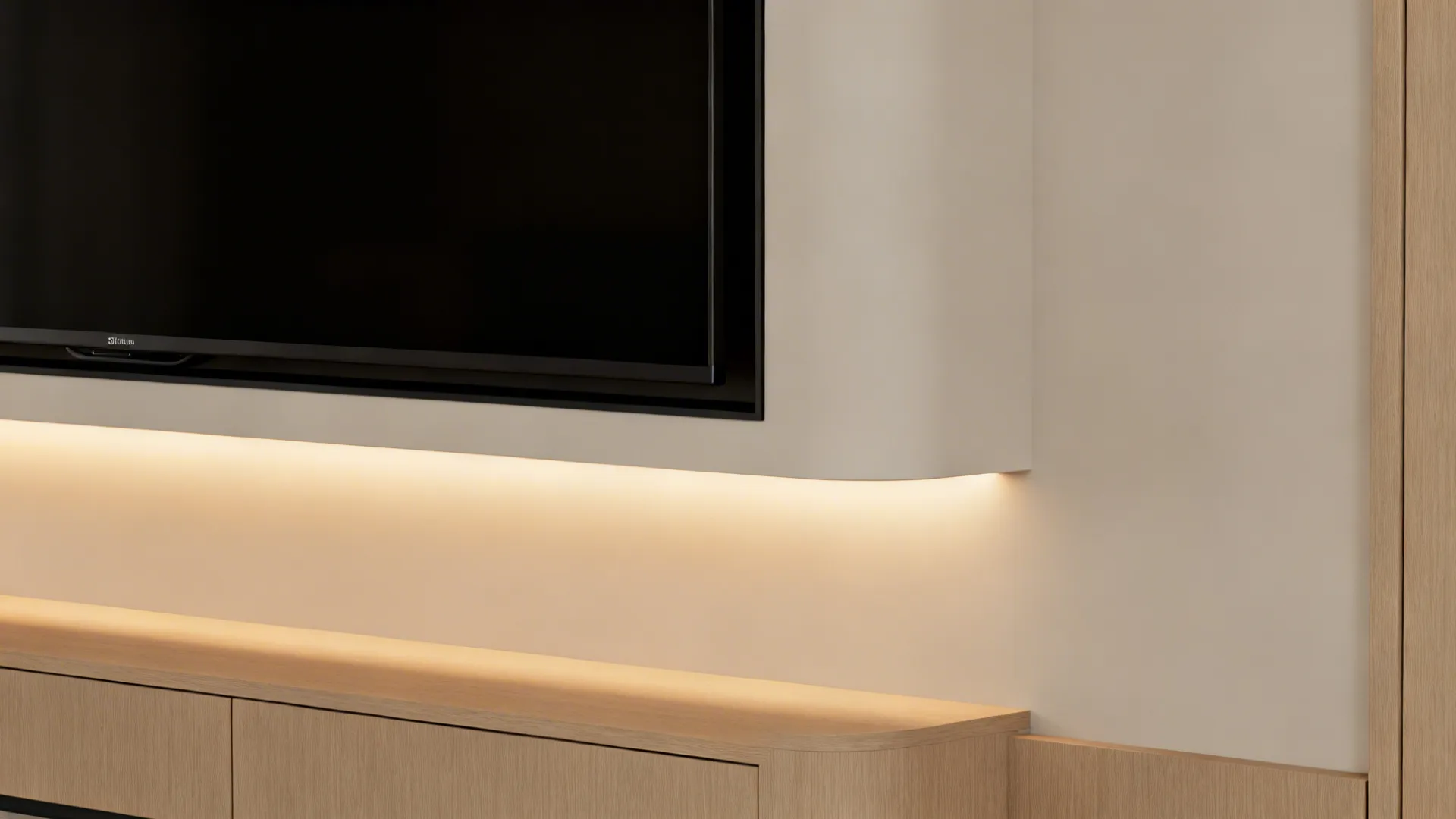Detail of a recessed TV niche with a warm LED halo and a clean shadow reveal.