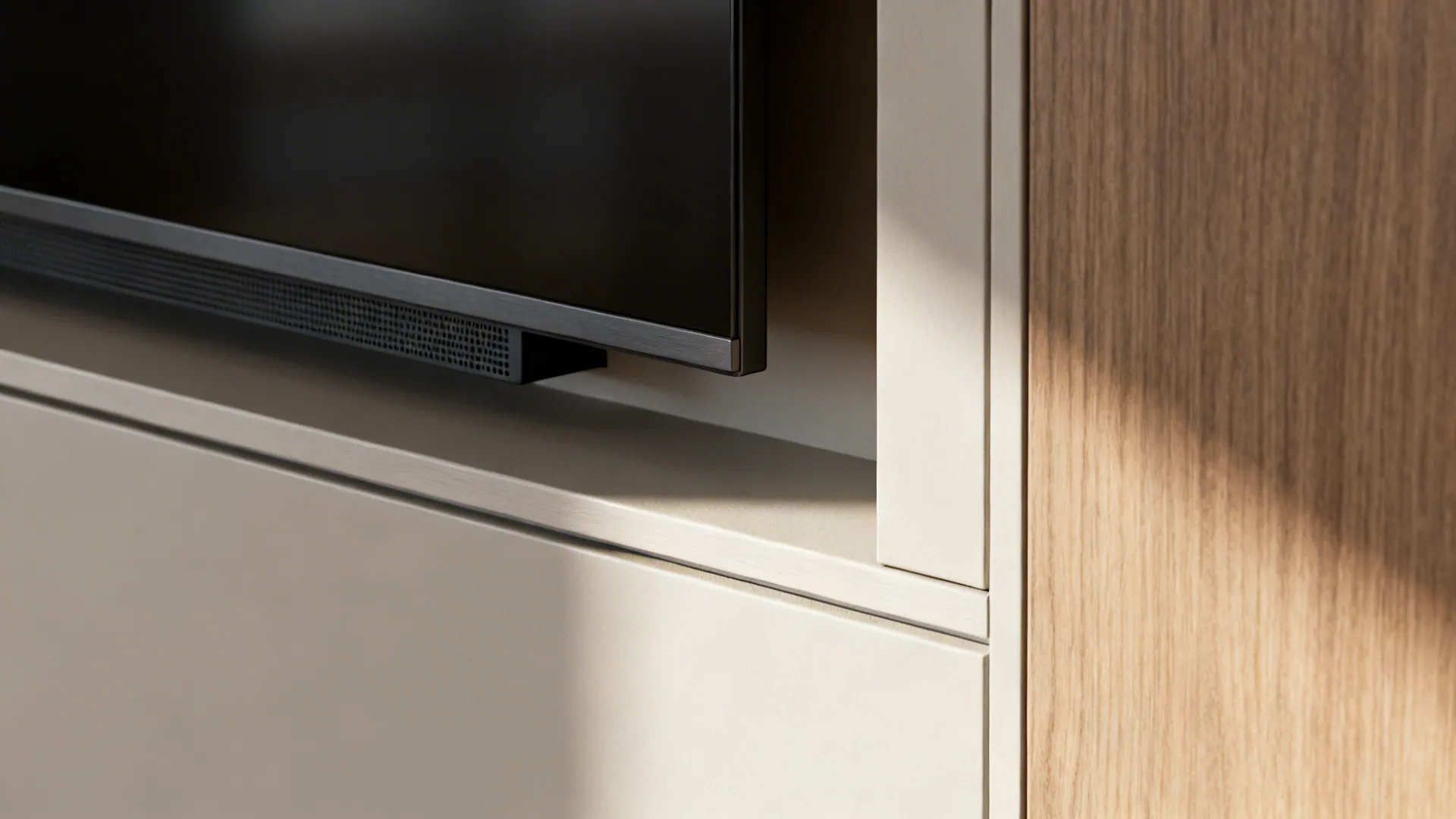 Macro detail of a recessed TV niche showing clean millwork edges and a discreet mesh vent.