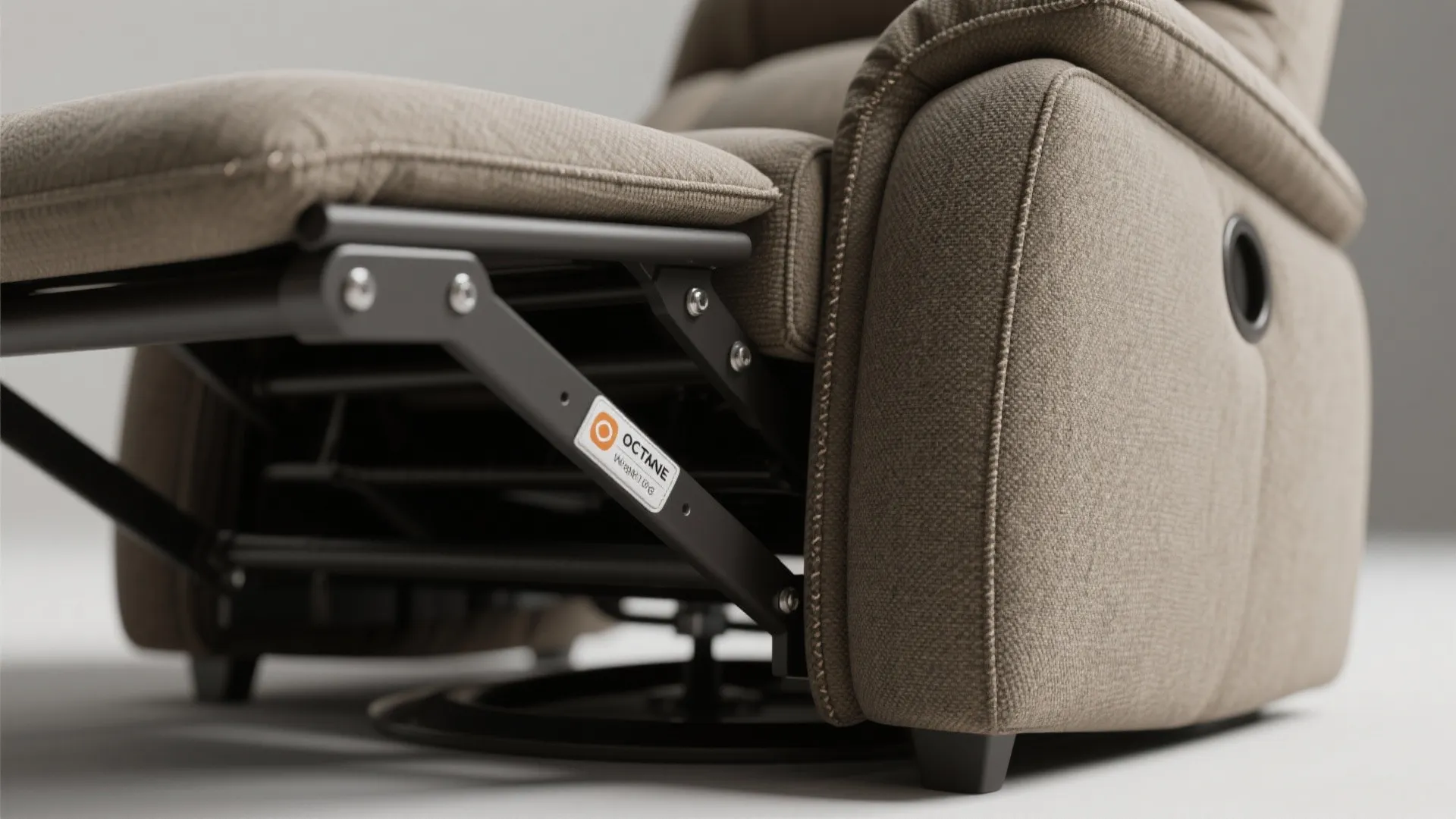 Close up of brown fabric sofa showing the metal frame and mechanical reclining seat parts