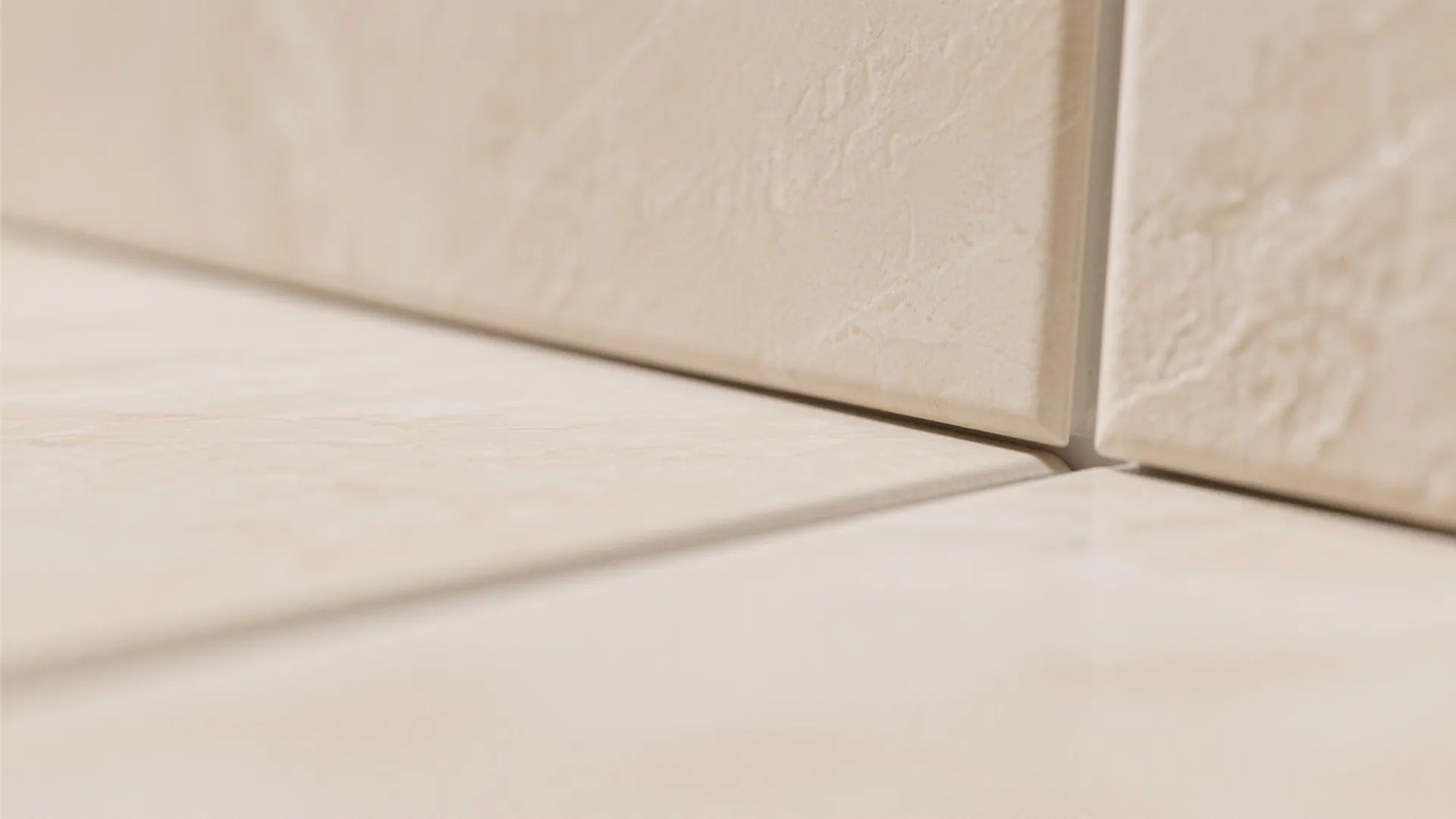 Close-up of light beige floor tiles showing clean grout lines and smooth matte surface texture