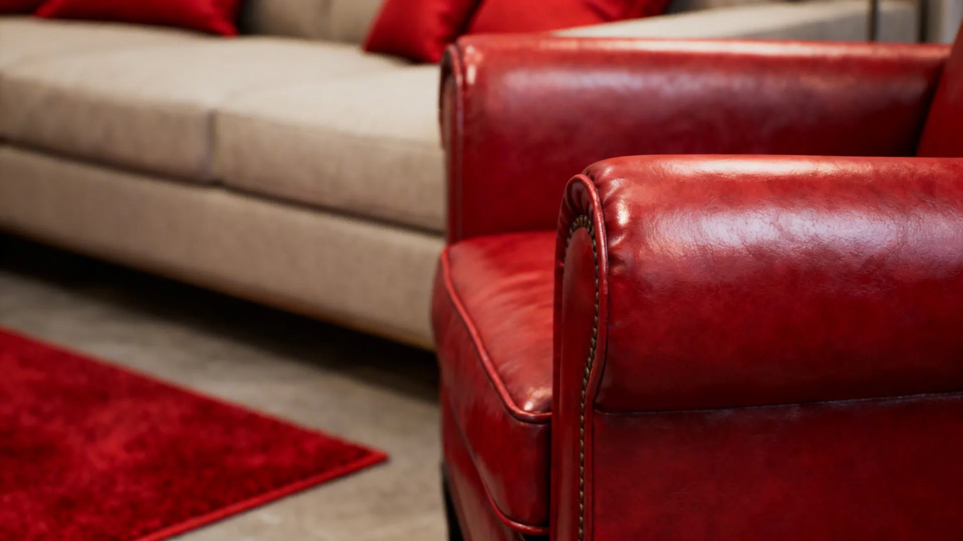 Close up of red leather chair next to a beige sofa and soft red rug