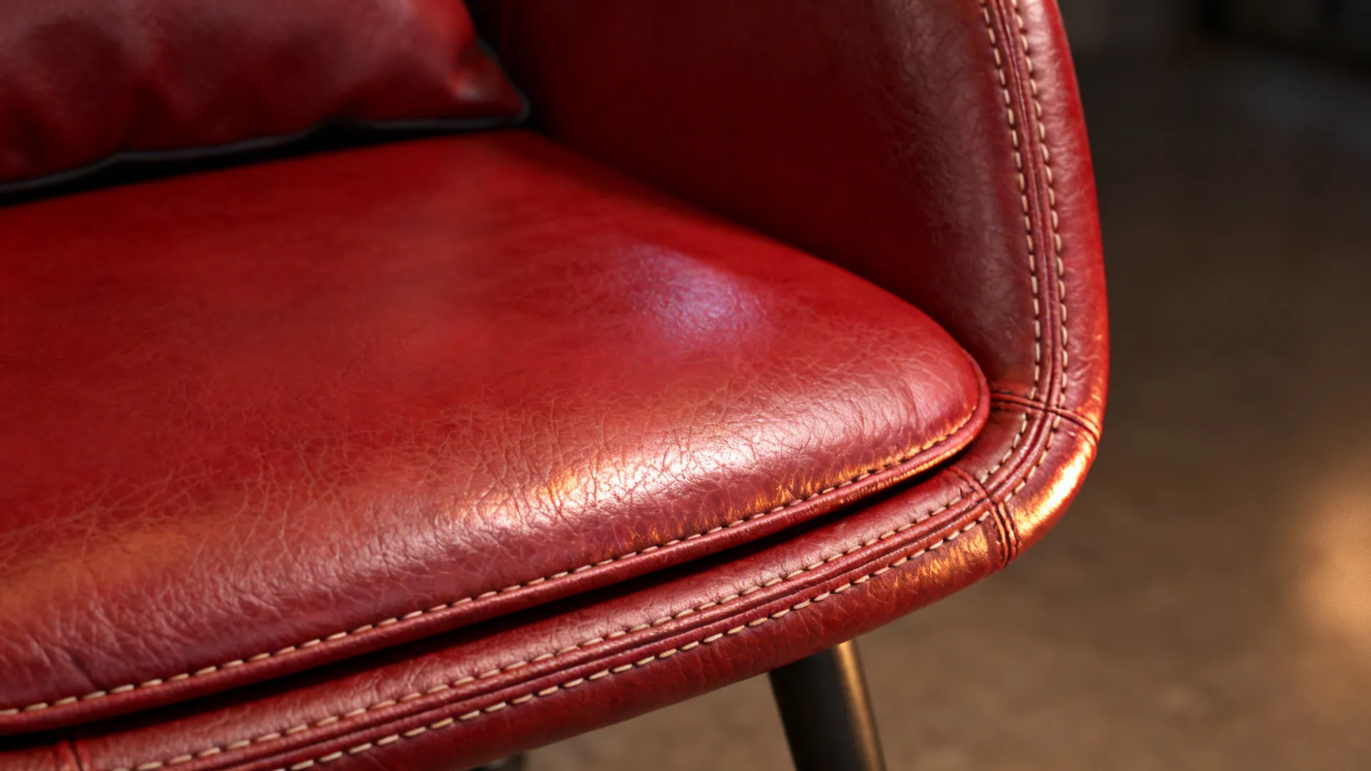 Macro detail of red leather chair showing grain and stitching for easy maintenance