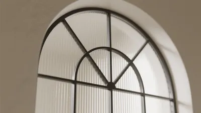Arched Window Design with Frosted Glass and Black Frame