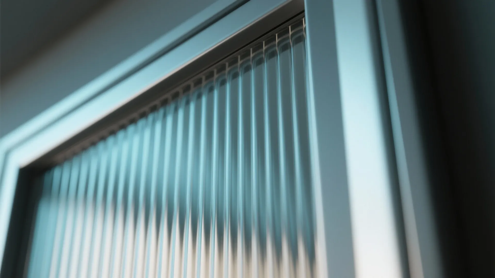 Close up of textured glass with vertical lines inside a grey metal frame for furniture
