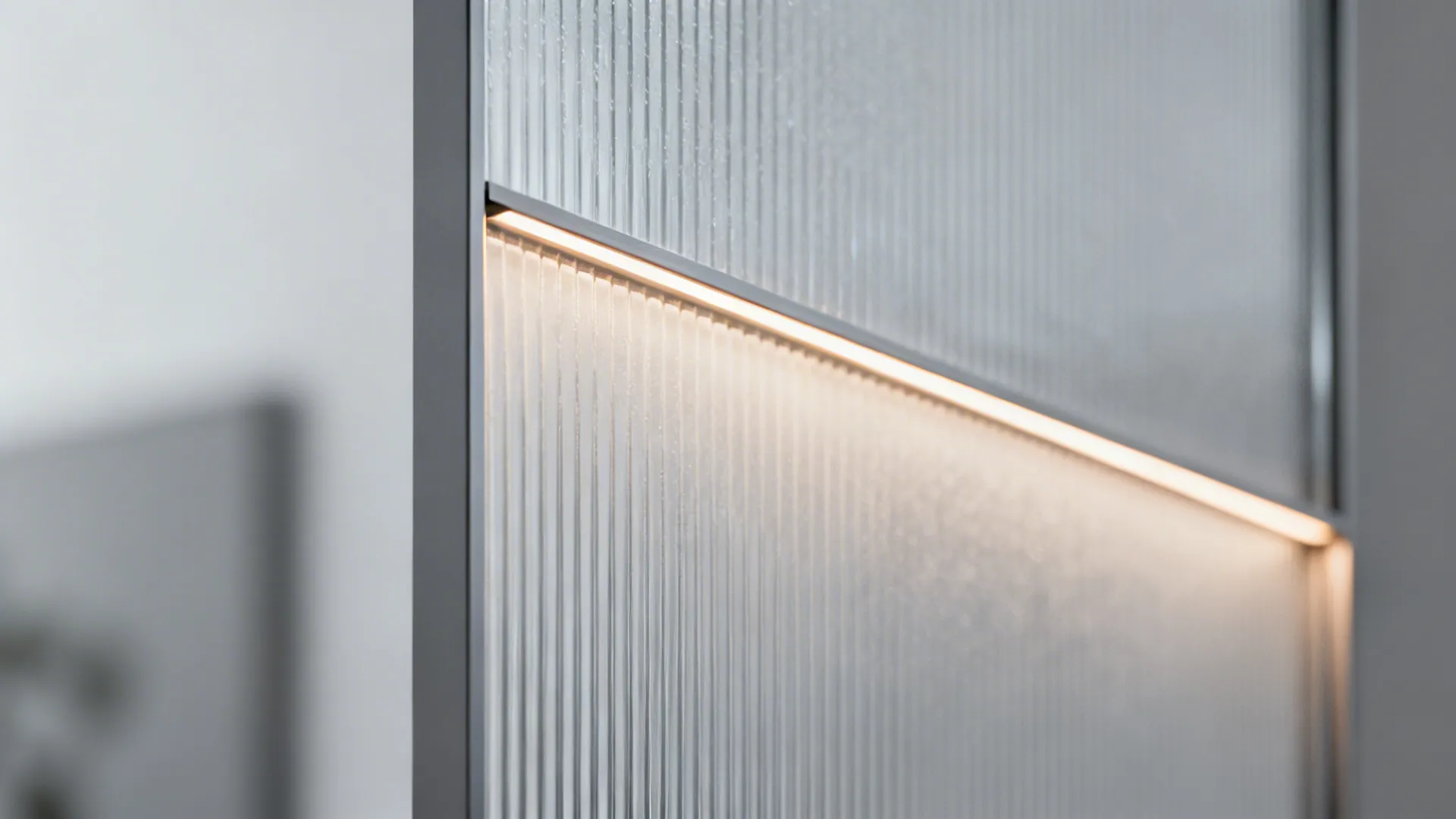 Macro texture of reeded frosted glass in a slim aluminum cabinet frame with LED glow.