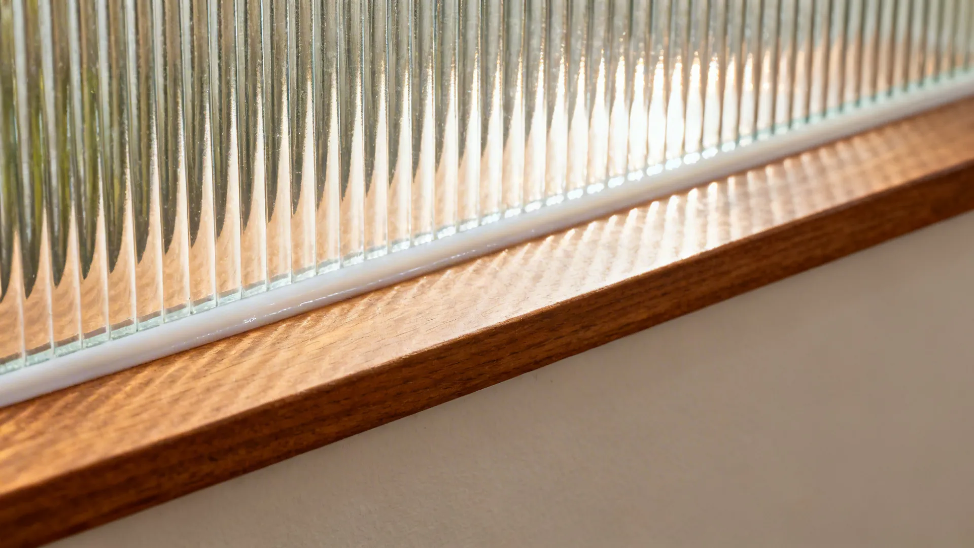 Half-height wall with reeded glass for soft separation