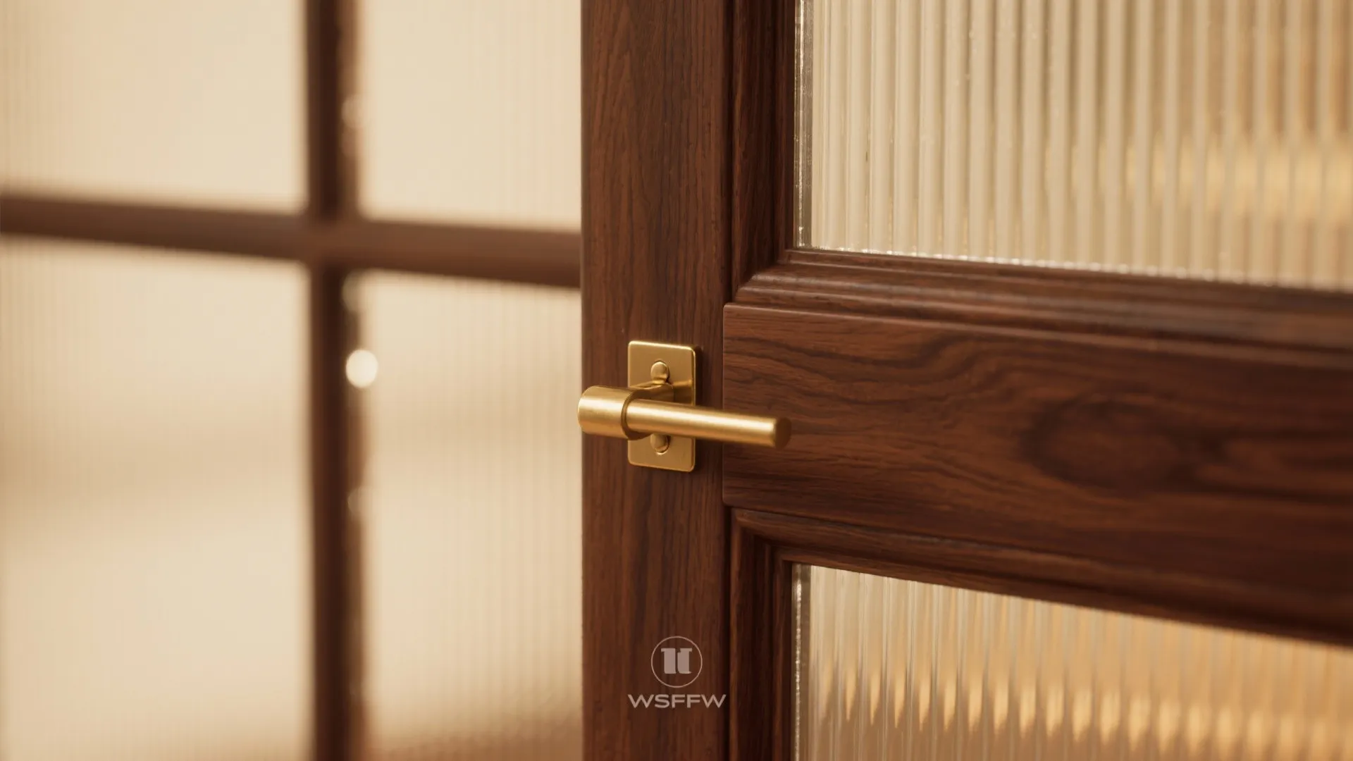 Close up view of dark wood door with textured glass panels and a gold handle