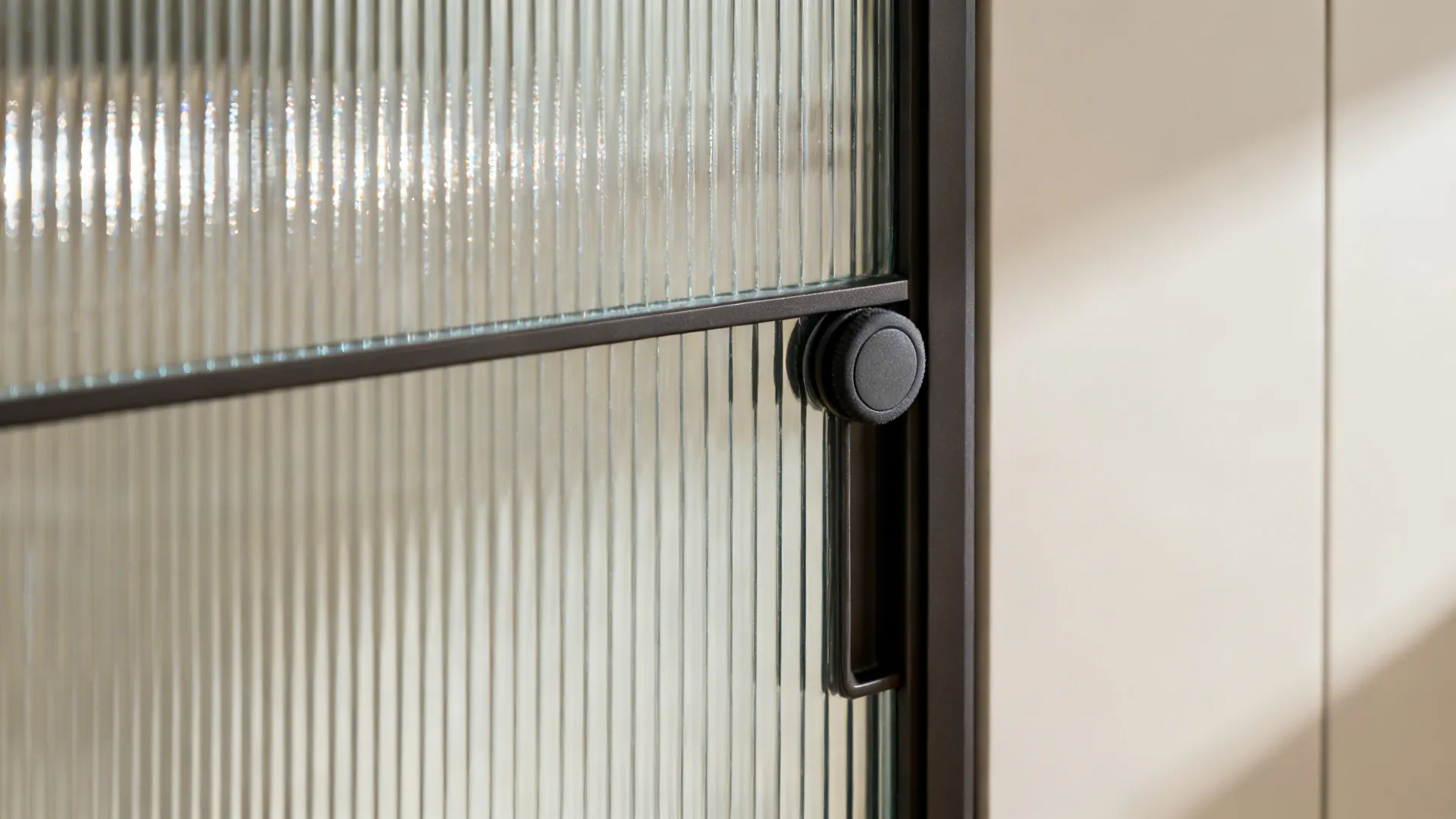Close-up of reeded tempered glass slider with soft roller and slim frame.