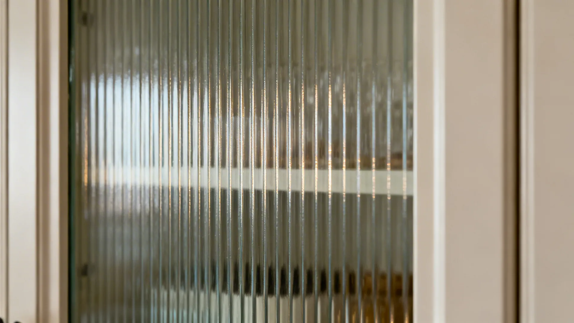Textured glass panel with vertical lines used for a modern kitchen cabinet door in a home
