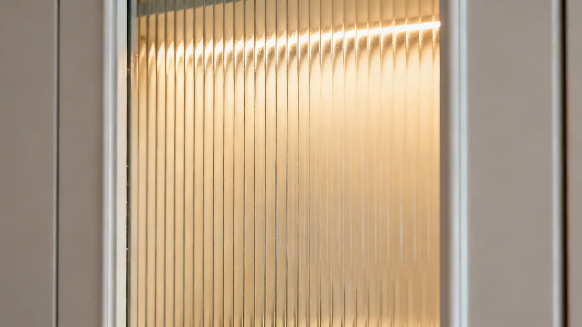 Macro of reeded glass insert with subtle vertical texture and warm glow.