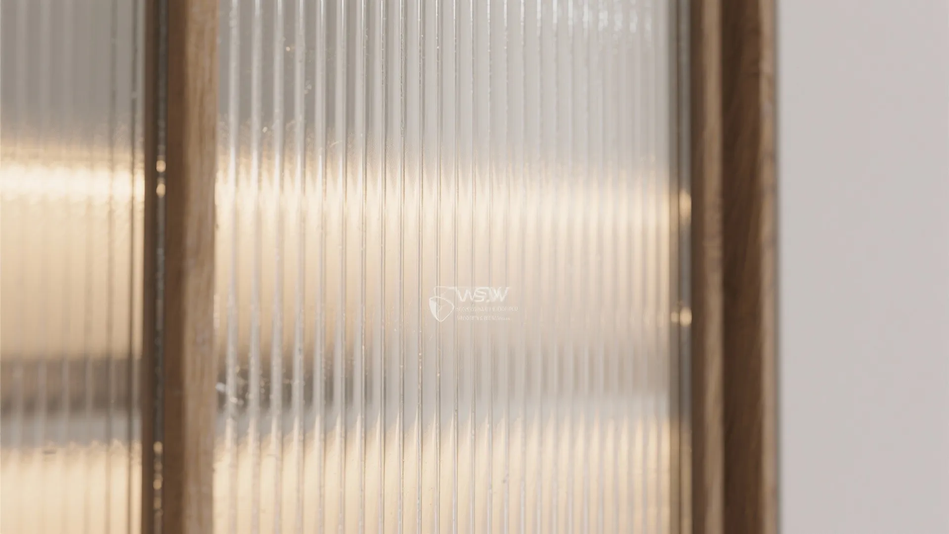 Close up of textured glass with vertical lines in a light brown wood frame indoor light