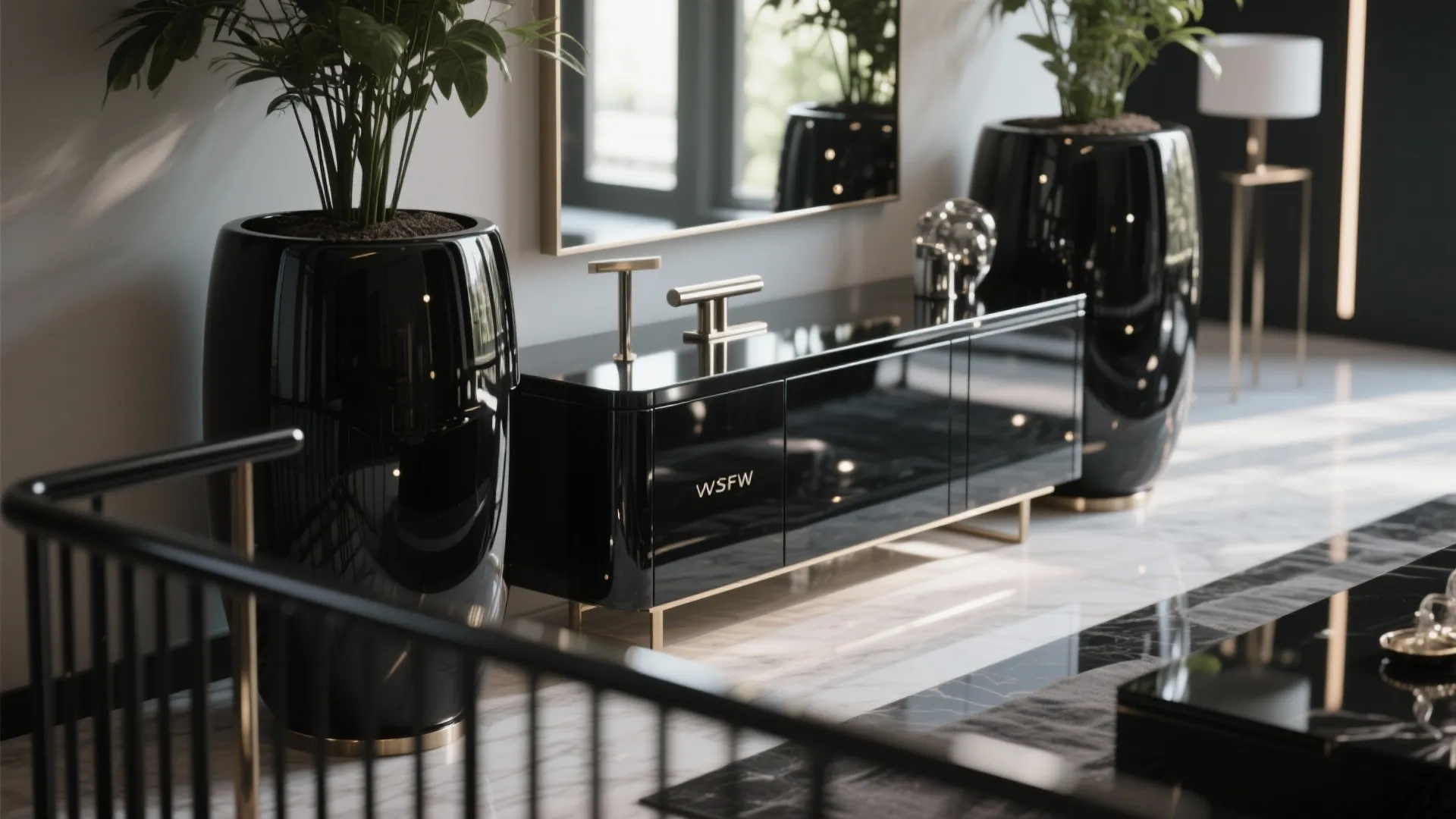 Modern interior featuring glossy black cabinet with gold legs and two large matching black ceramic vases