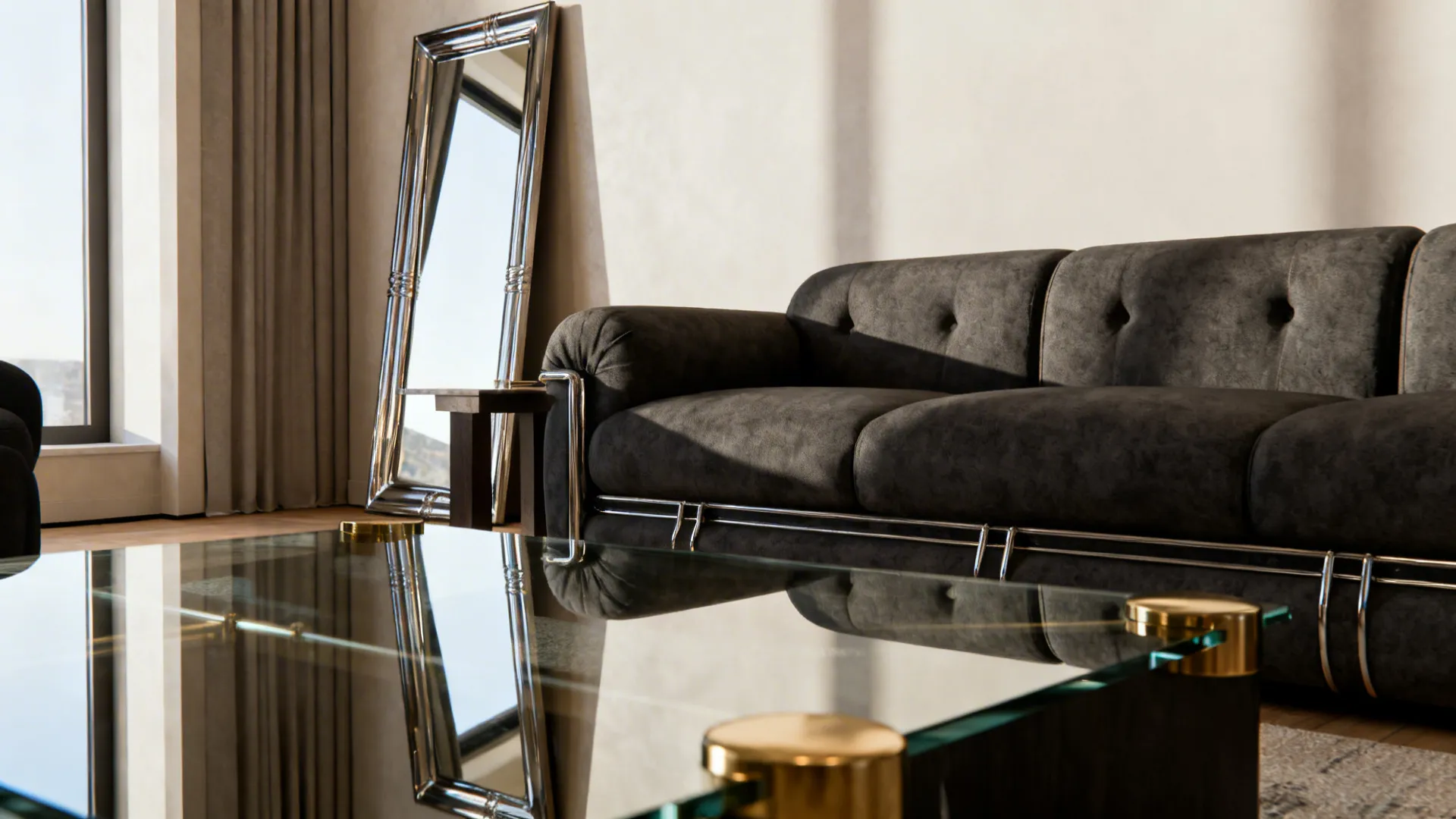 Glass coffee table with gold details in front of dark sofa and tall silver mirror