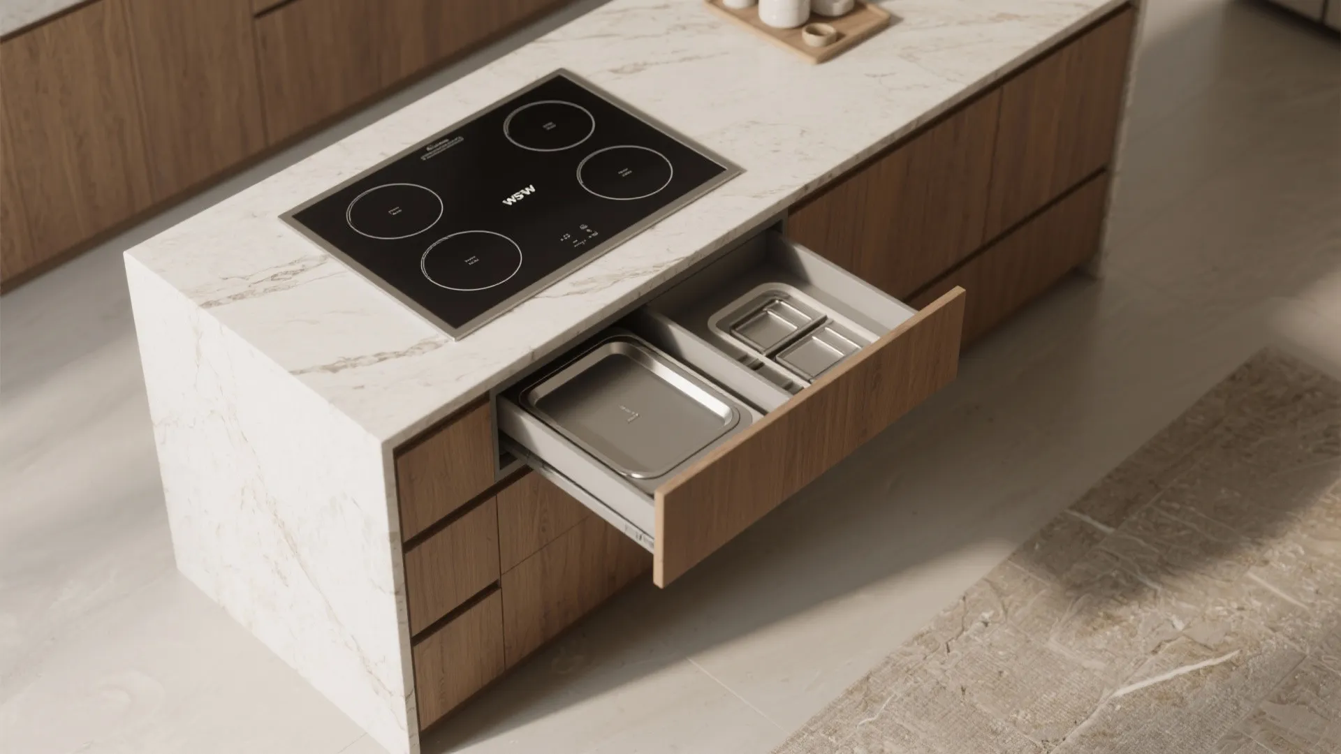 White marble kitchen island with black cooktop and open drawer showing organized metal storage trays