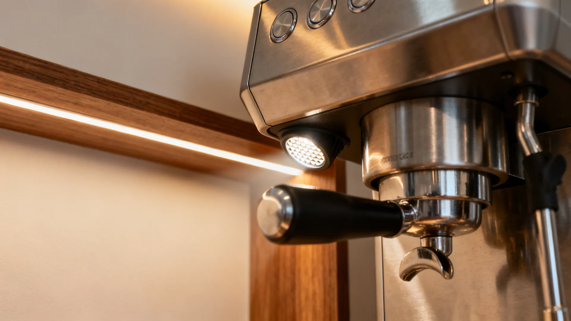 Macro of high-CRI accent lighting aimed at a stainless espresso machine with minimal glare.