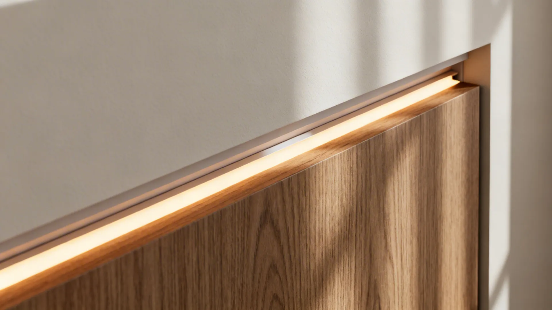 Warm light strip hidden behind a horizontal wood wall panel to create a soft glow