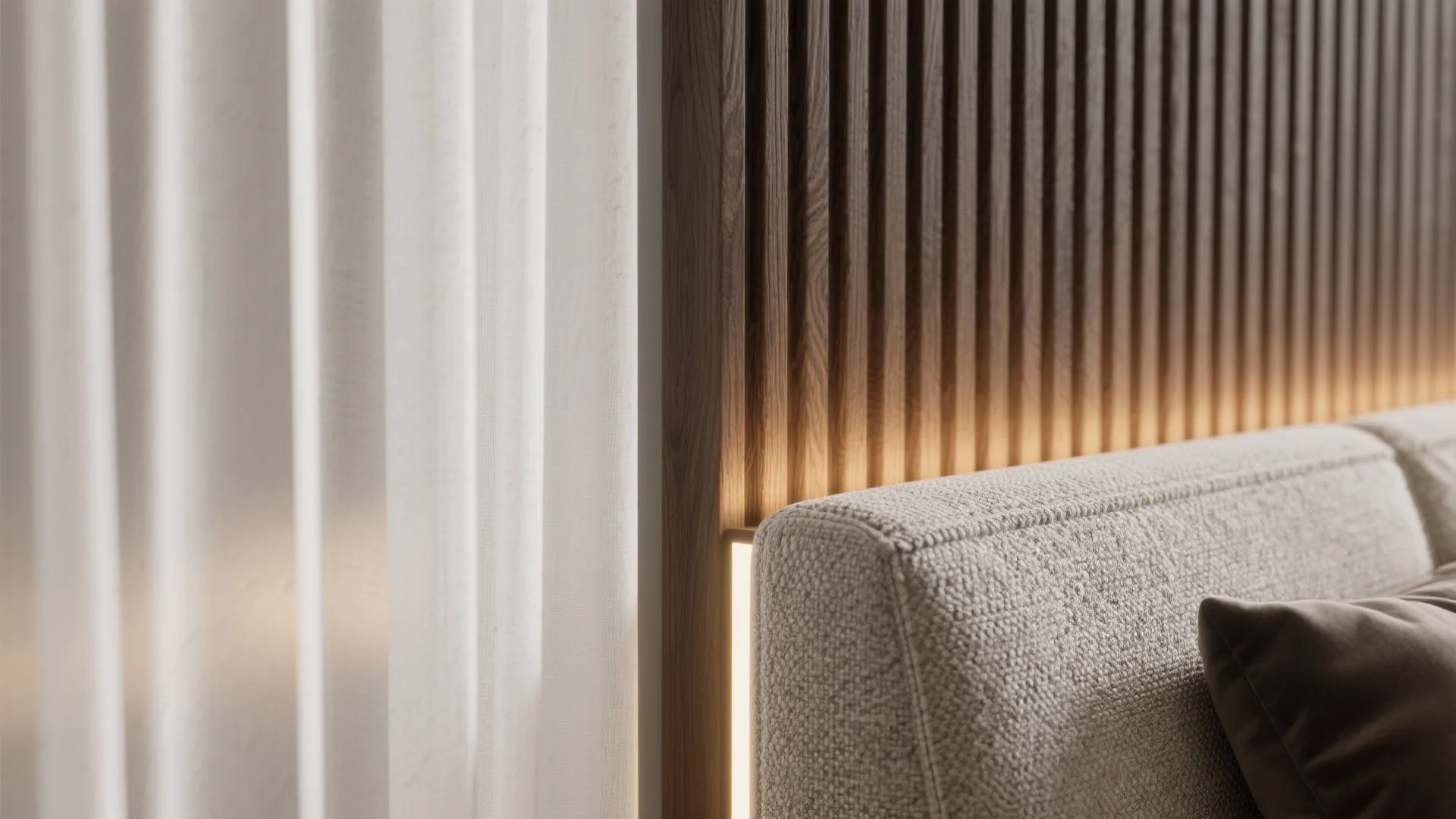 Close-up of textured fabric sofa against vertical wood wall panel with warm hidden light curtains