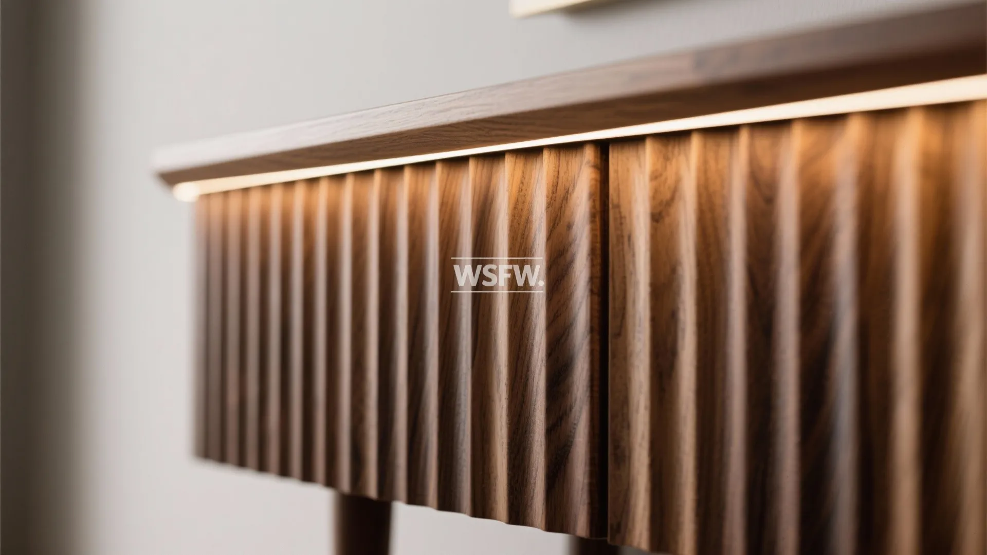 Macro of ribbed oak console texture highlighted by warm grazing light.