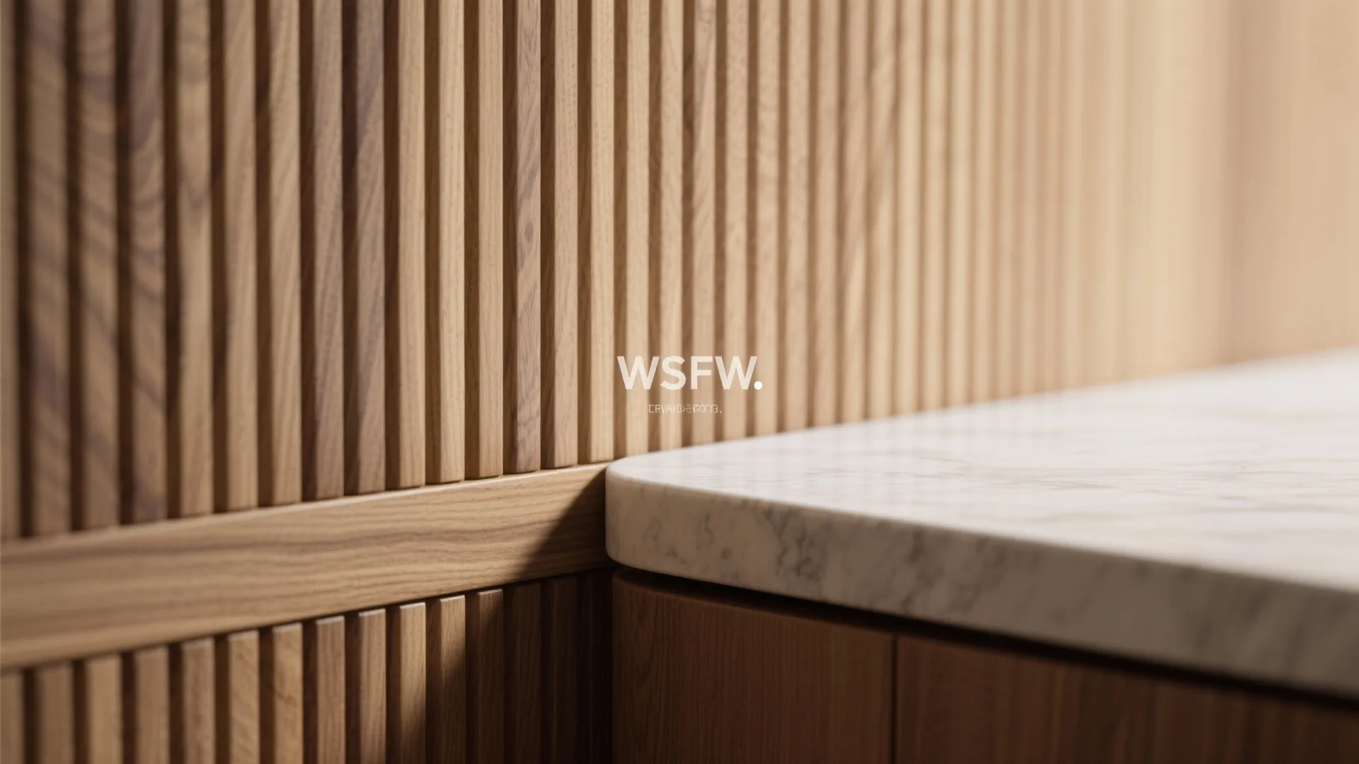 Close up of vertical wood wall panel next to white marble counter and white logo