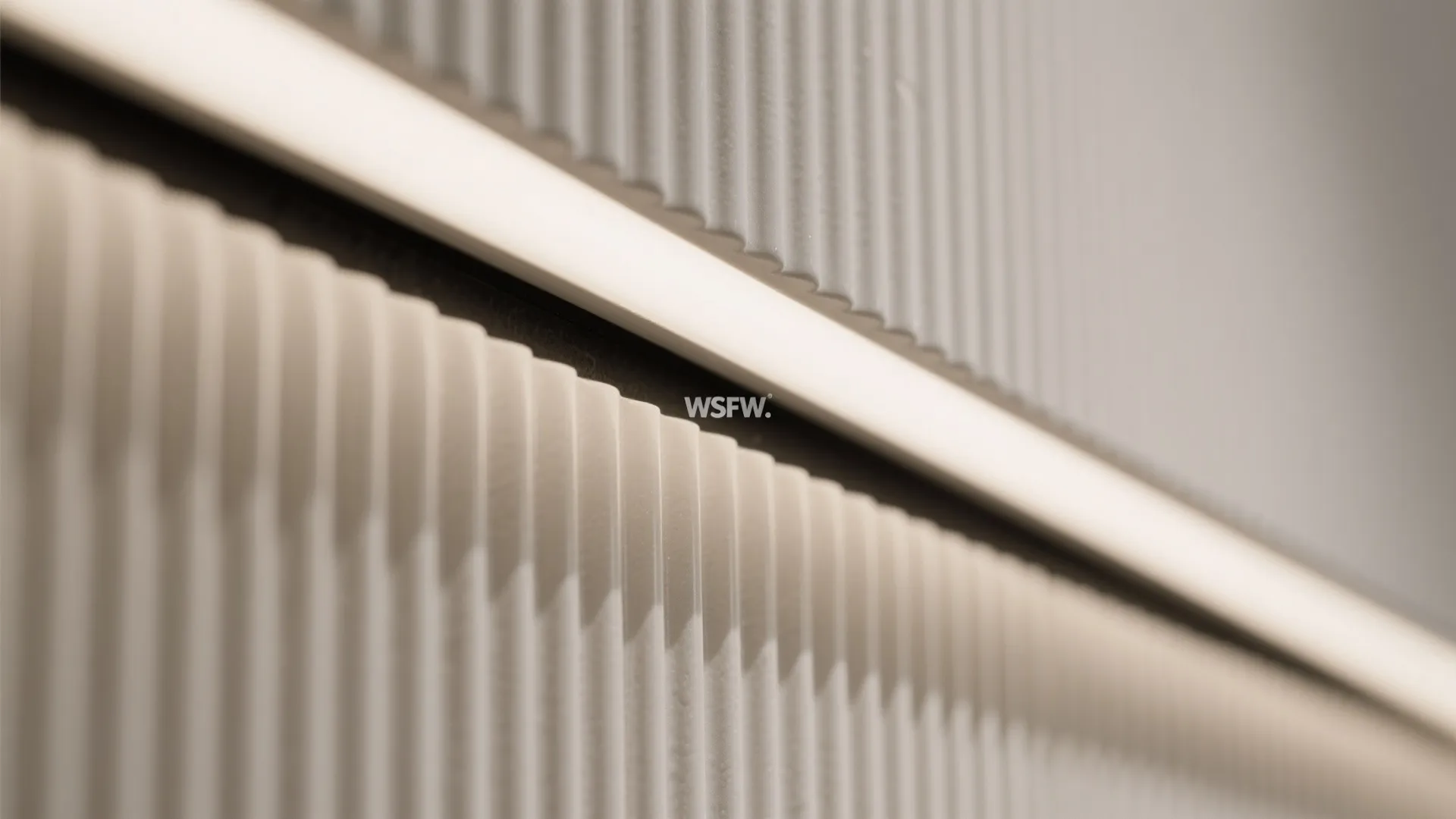 4) Subtle linear ribbed wall tiles for height and acoustic softness