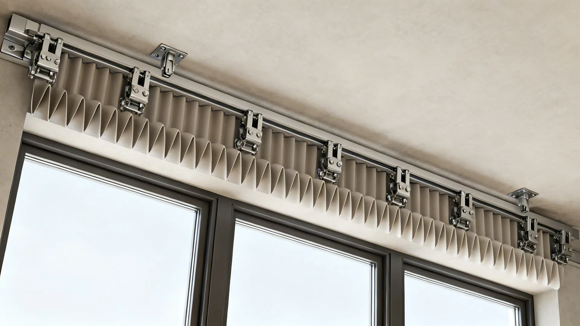 Top-down view of ripplefold ceiling track with consistent wave depth over three windows.