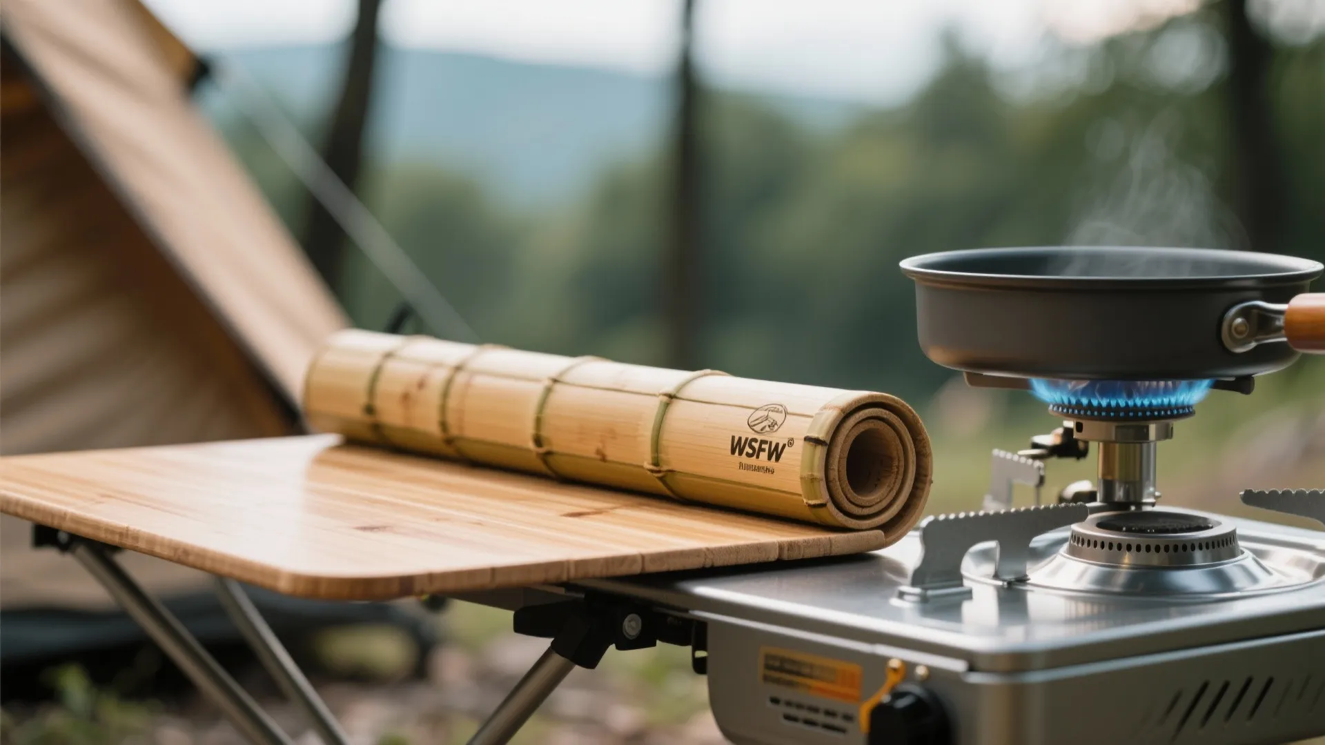 Bamboo mat on a wooden table next to a portable gas stove with cooking pan