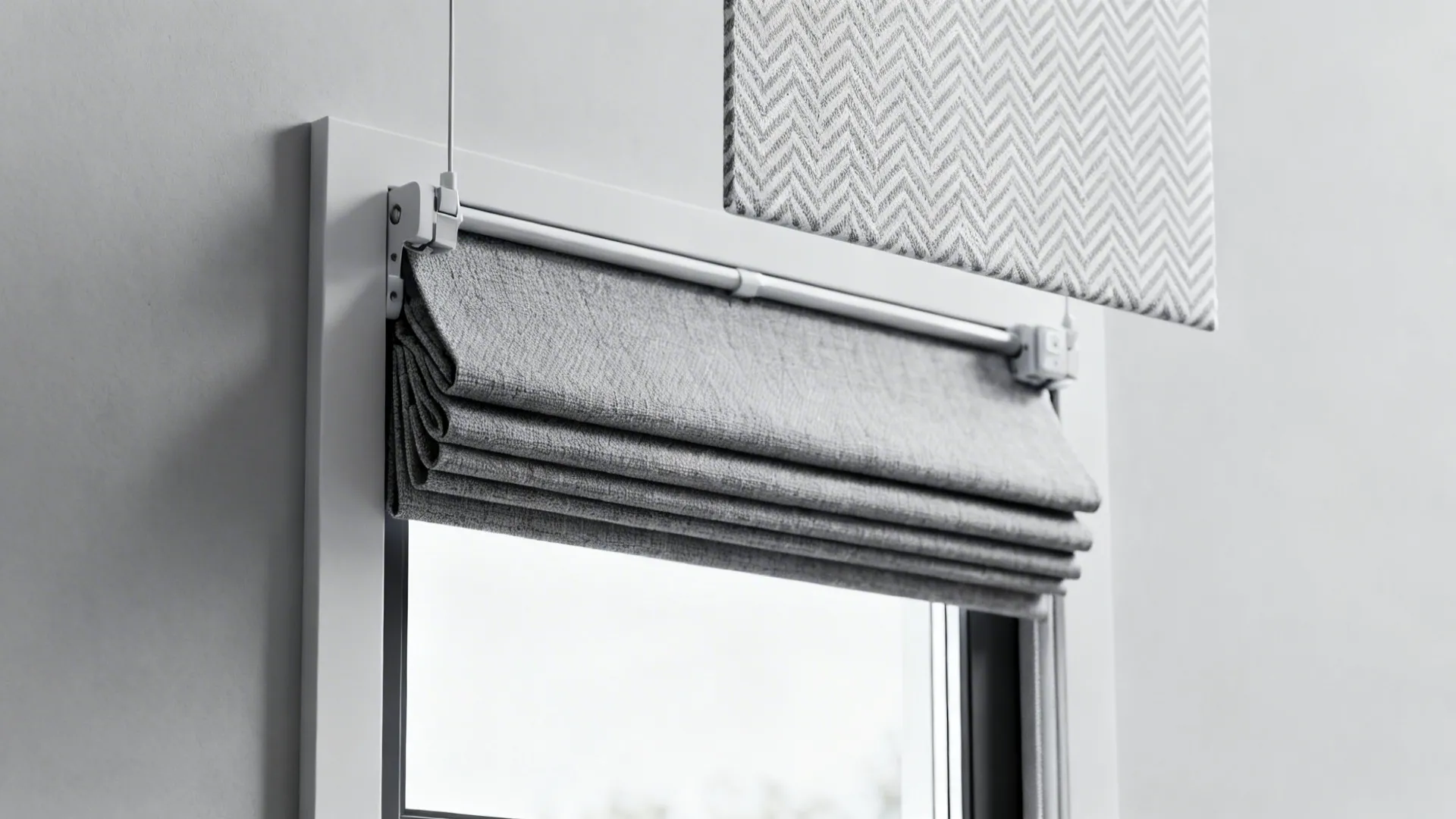 Grey and white geometric Roman shade sample over a small window